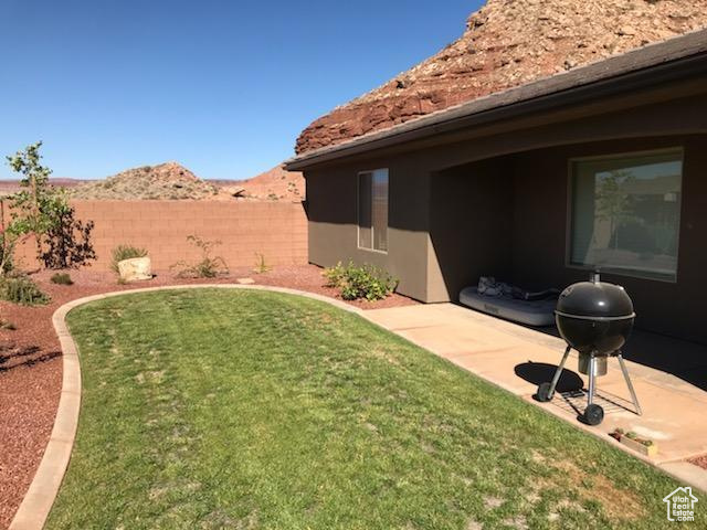 View of yard with a mountain view and a patio area