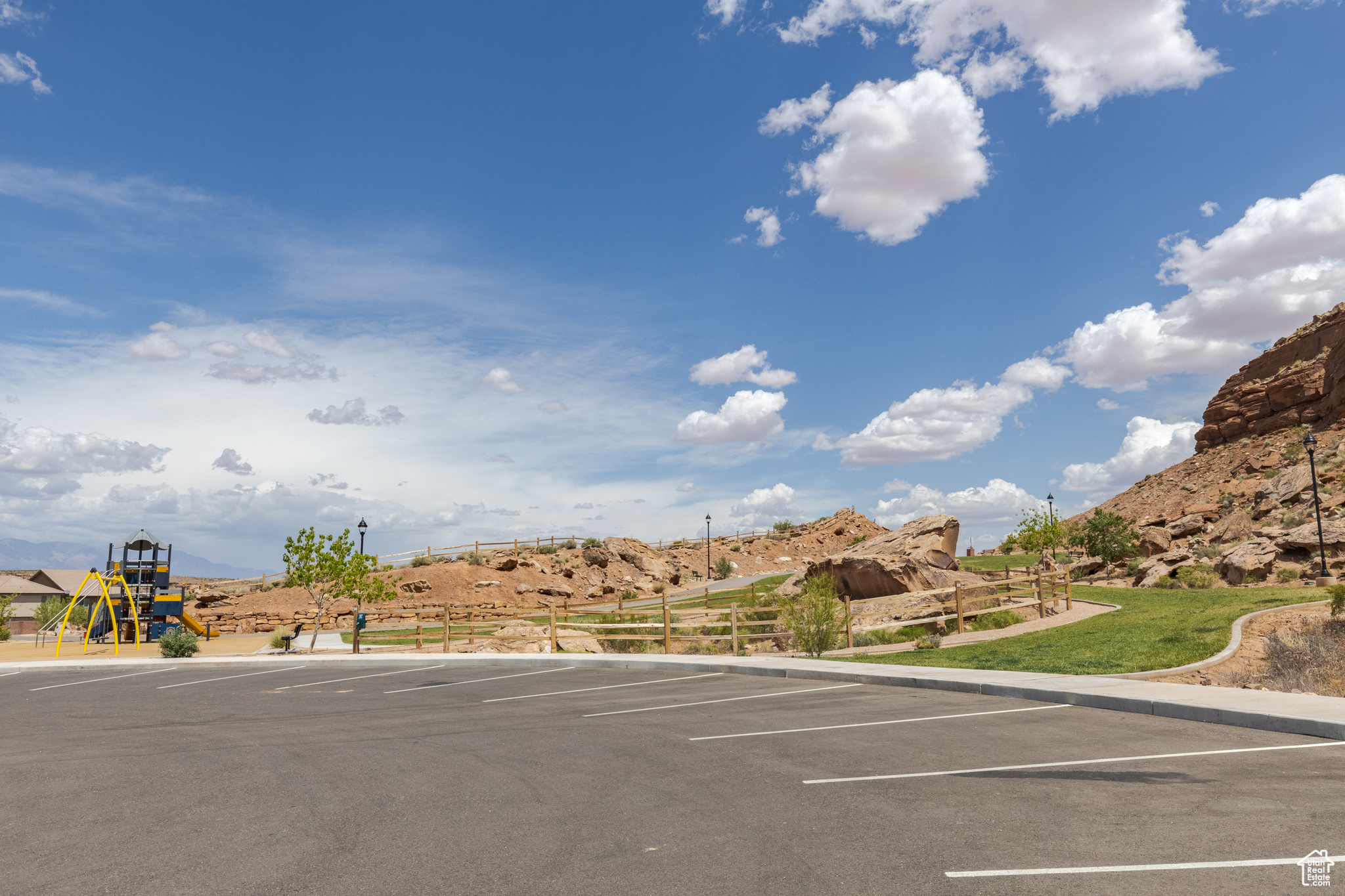 View of parking with a playground and a mountain view