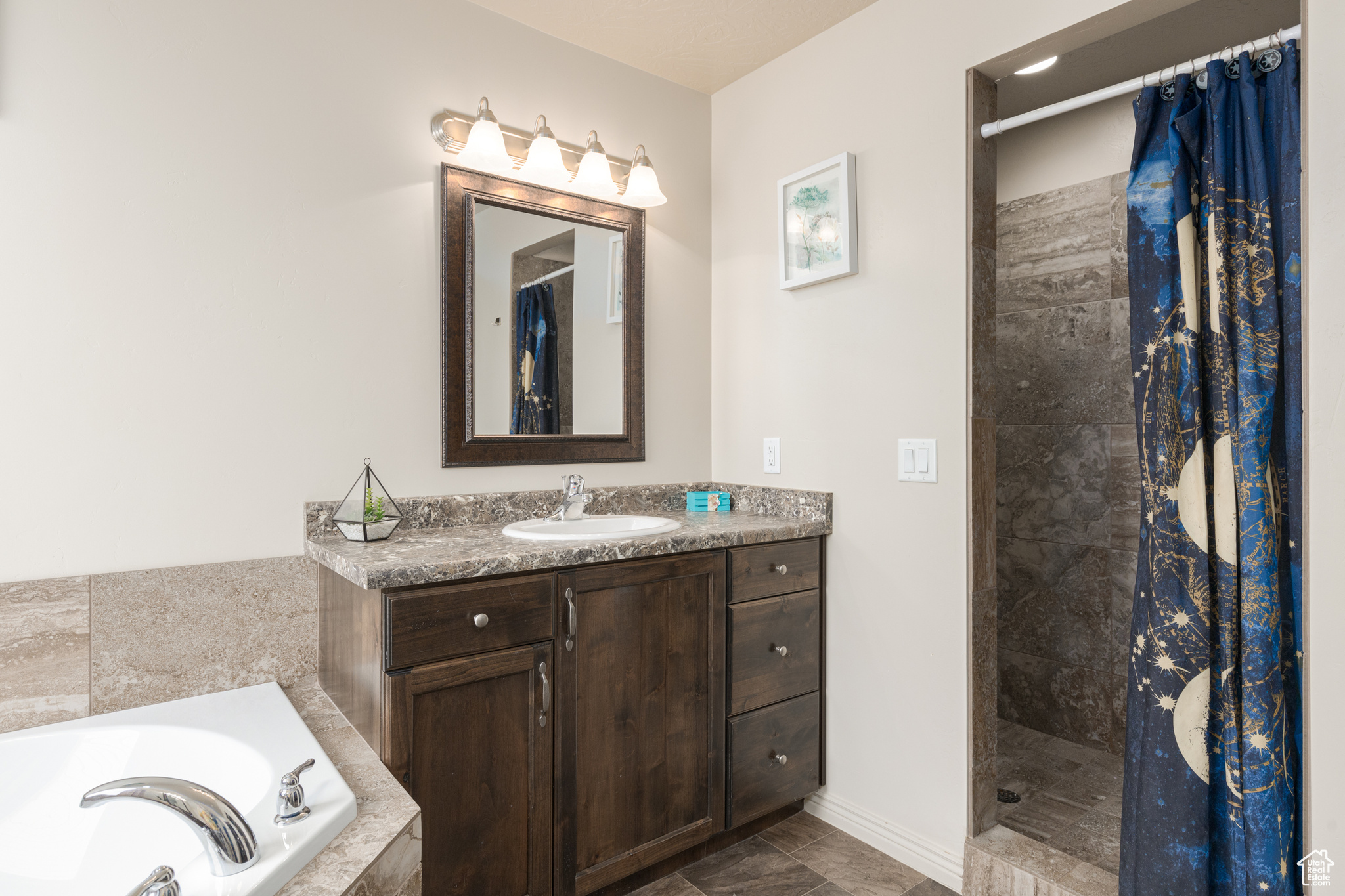 Bathroom featuring separate shower and tub, tile floors, and vanity