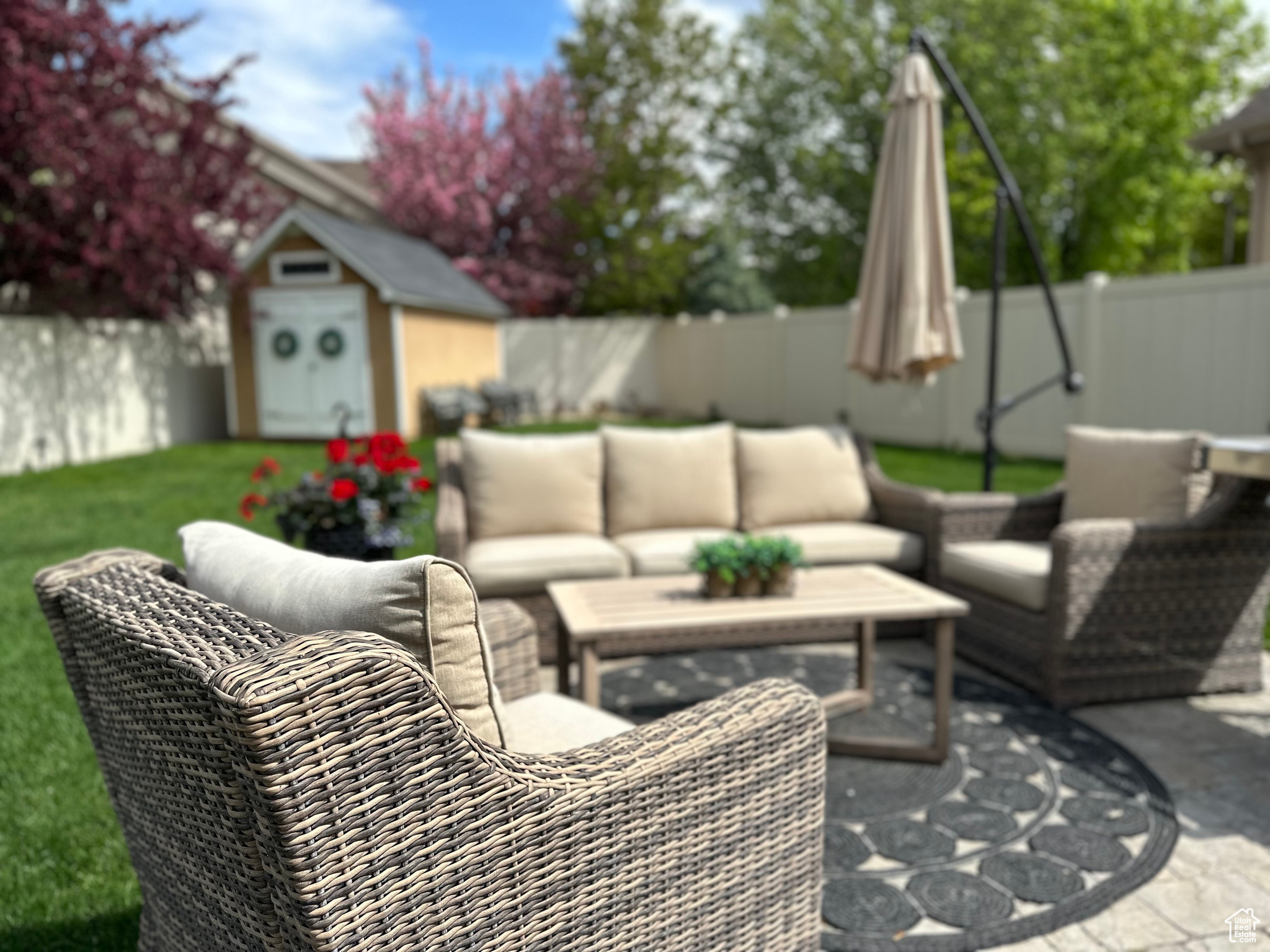 Back yard with patio furniture that is included in the sale