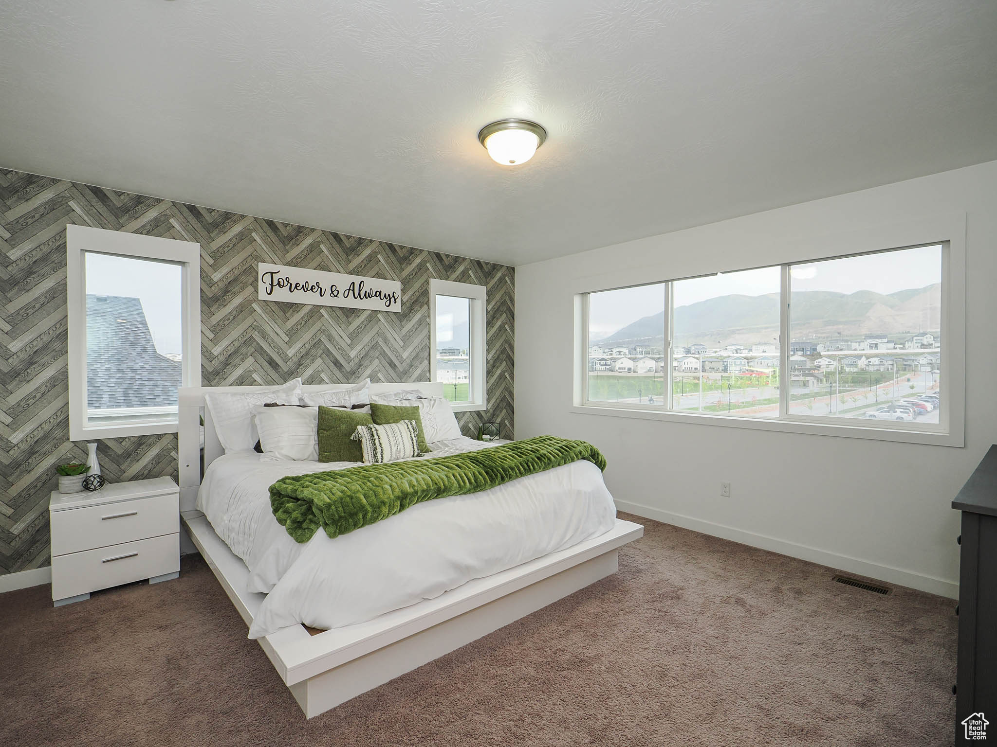 Bedroom featuring a mountain view and dark carpet