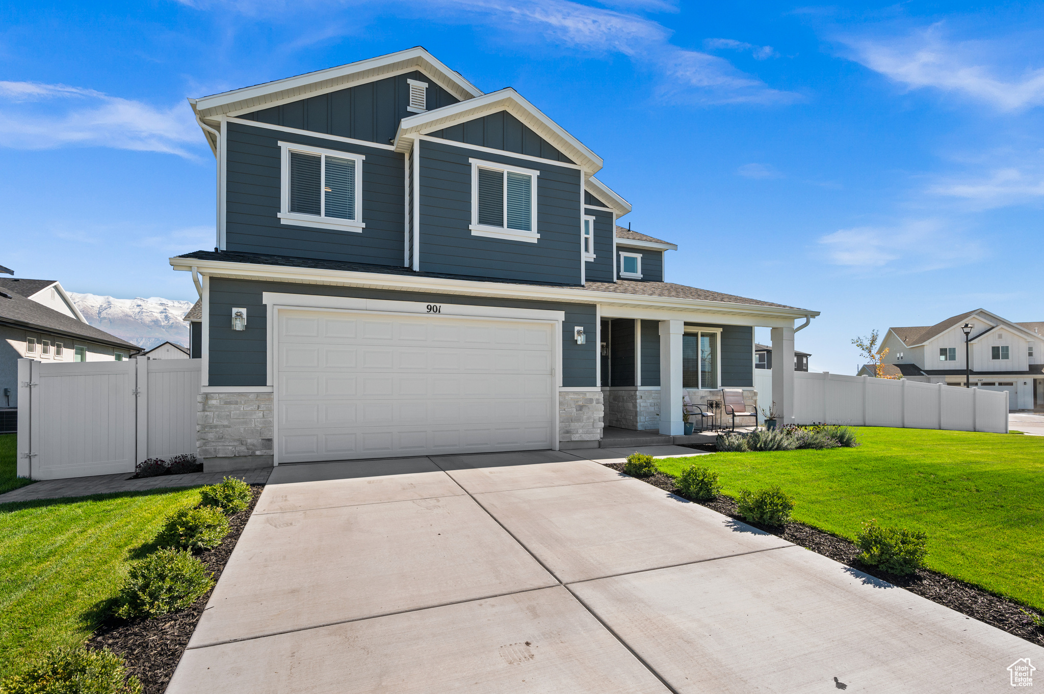 Craftsman-style house featuring a front yard and a garage