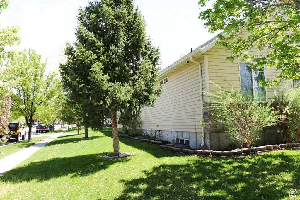 View of side of property with a yard