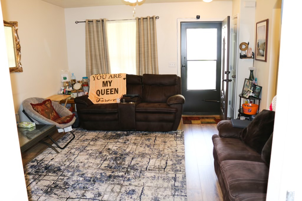 Living room with hardwood / wood-style flooring