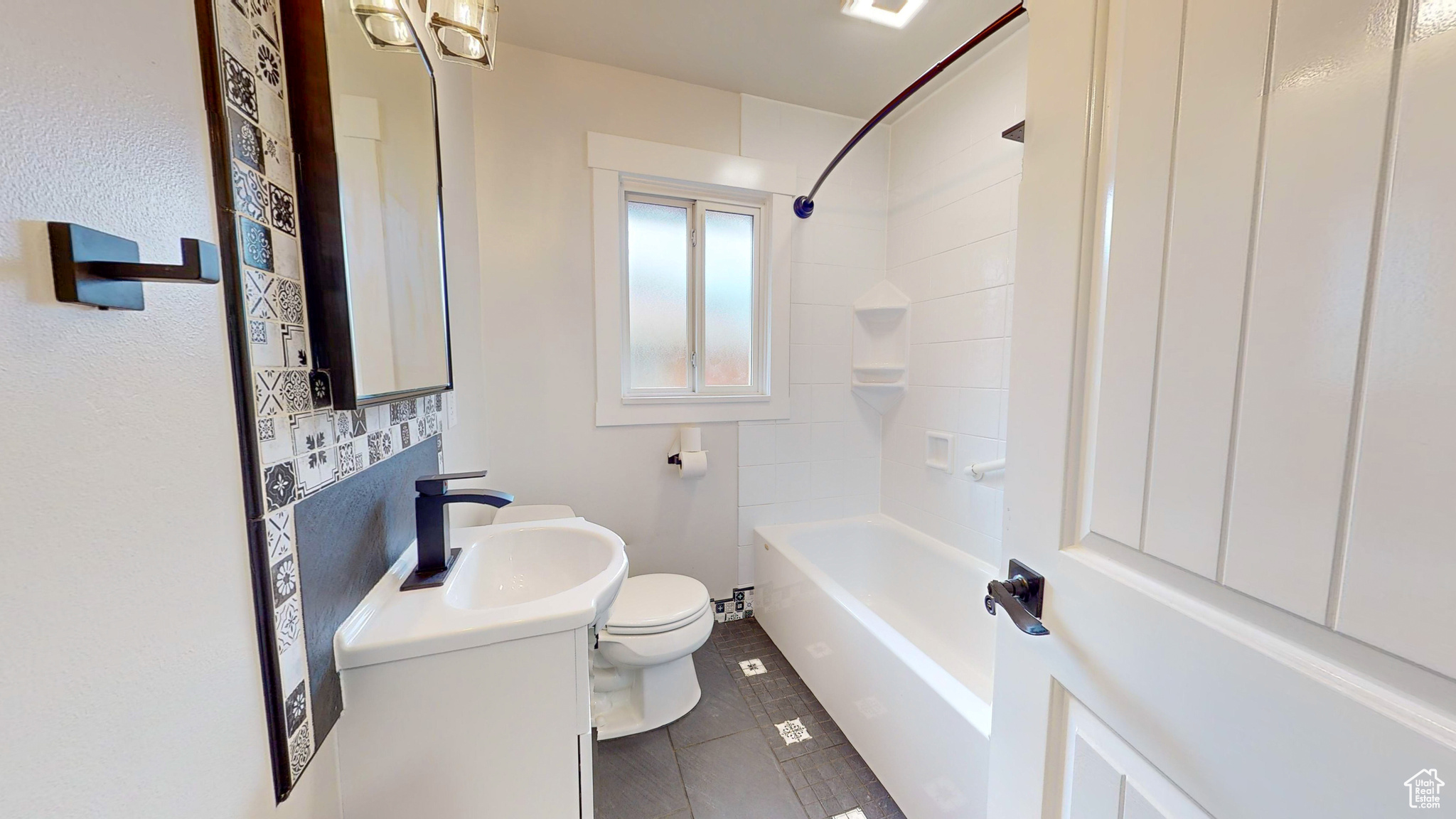 Full bathroom with tile flooring,  shower combination, toilet, and large vanity