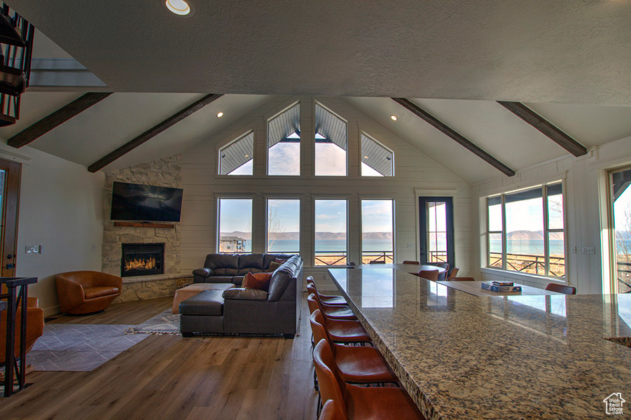 Interior space featuring high vaulted ceiling, beam ceiling, and hardwood / wood-style flooring