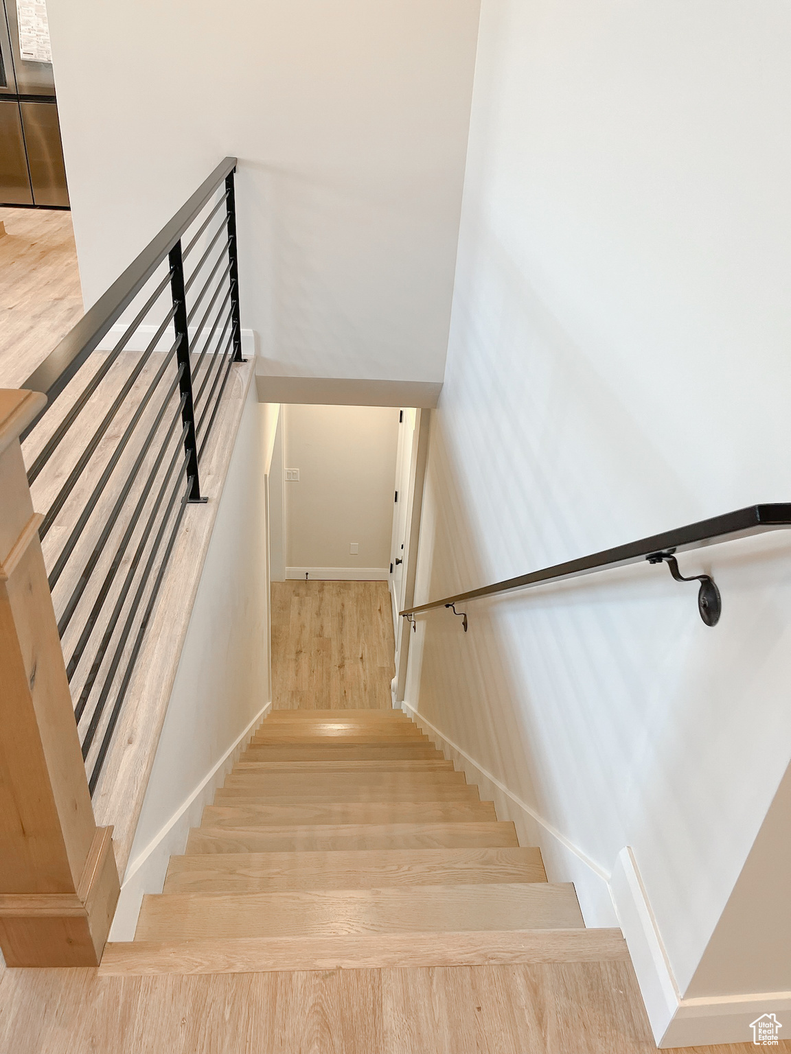 Stairway with light wood-type flooring