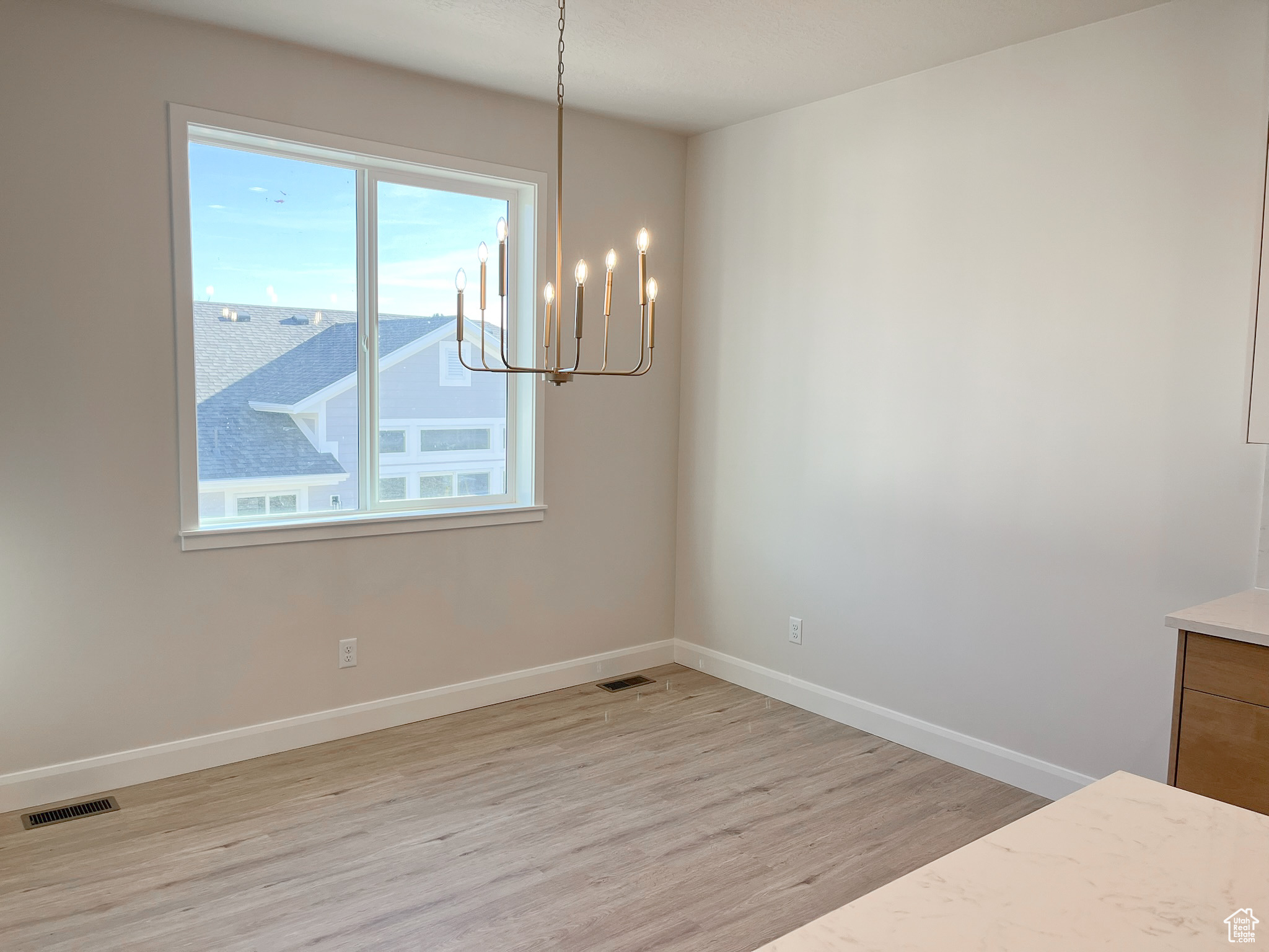 Interior space featuring an inviting chandelier and light hardwood / wood-style floors