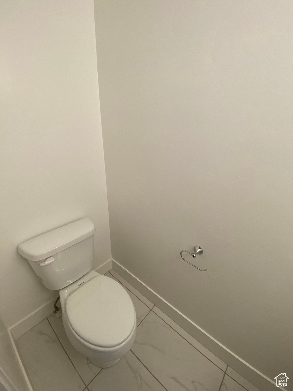 Bathroom featuring toilet and tile flooring