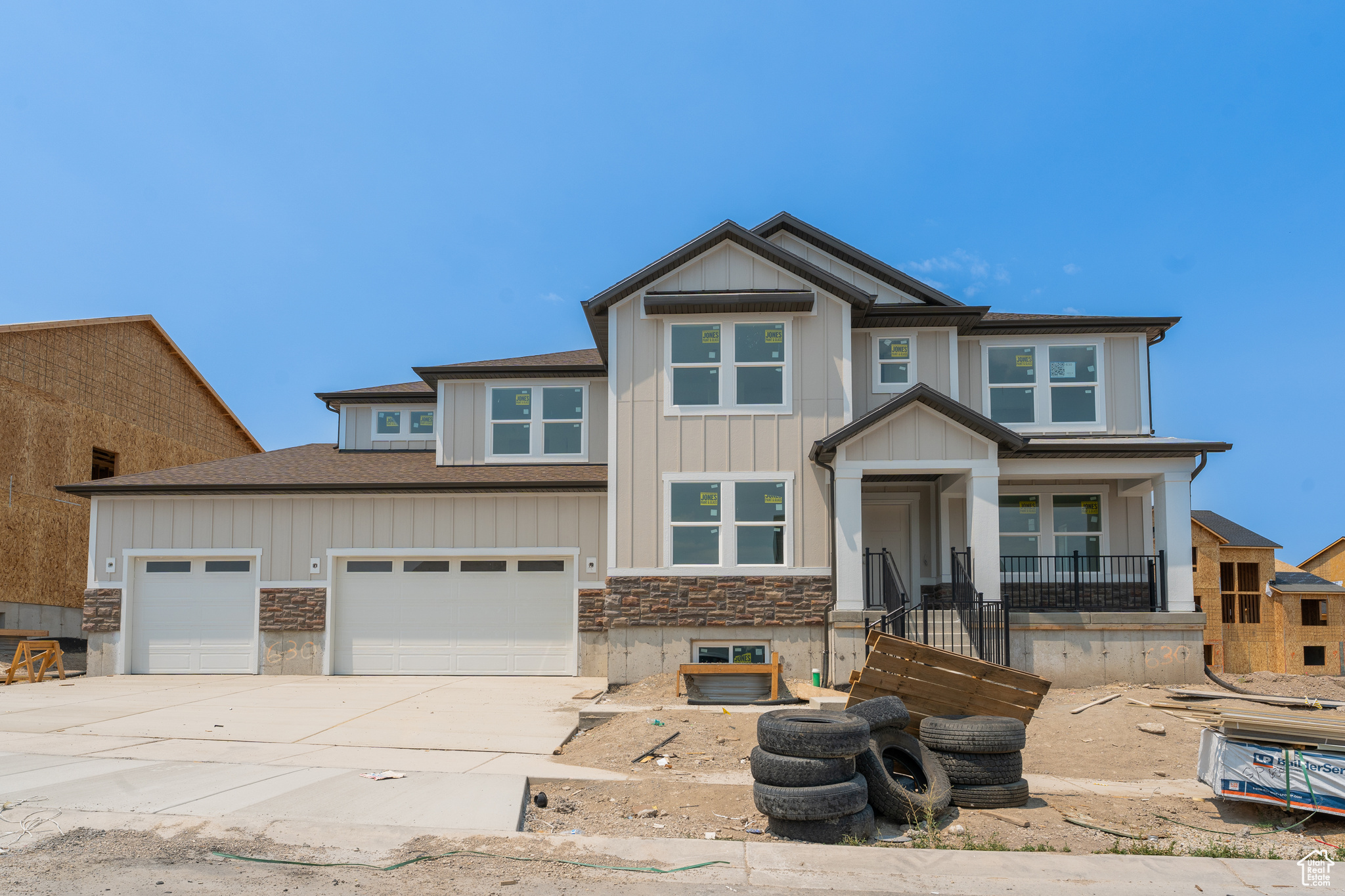 View of front of property featuring a garage and a porch