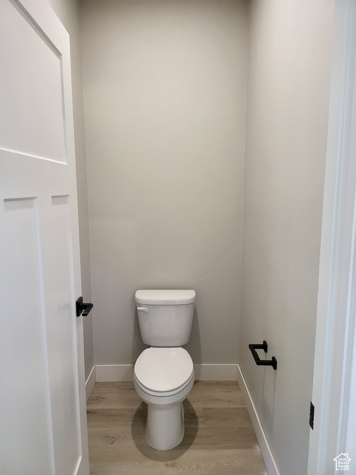 Bathroom featuring toilet and wood-type flooring