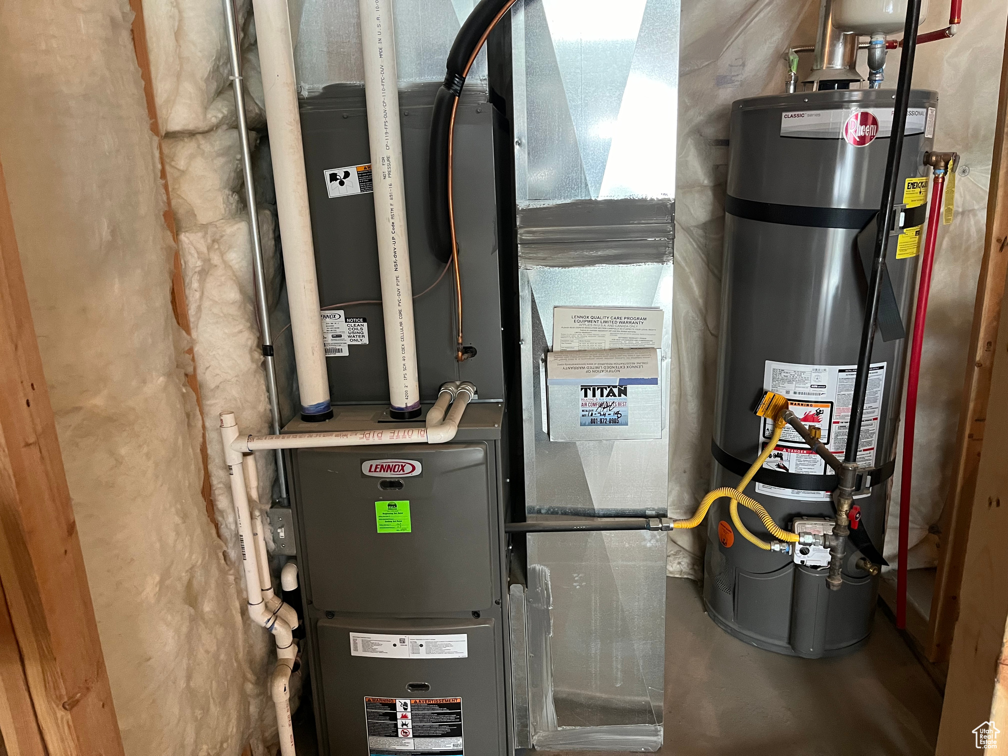 Utility room featuring strapped water heater