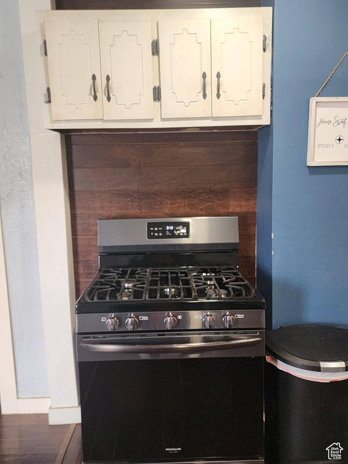 Kitchen with hardwood / wood-style floors and stainless steel gas stove