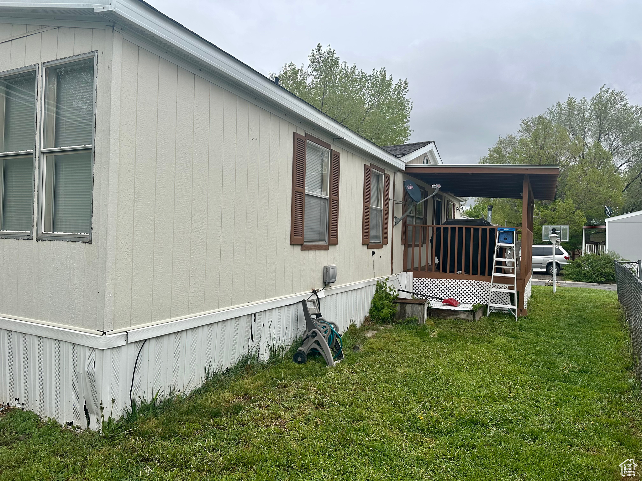 View of side of home featuring a yard