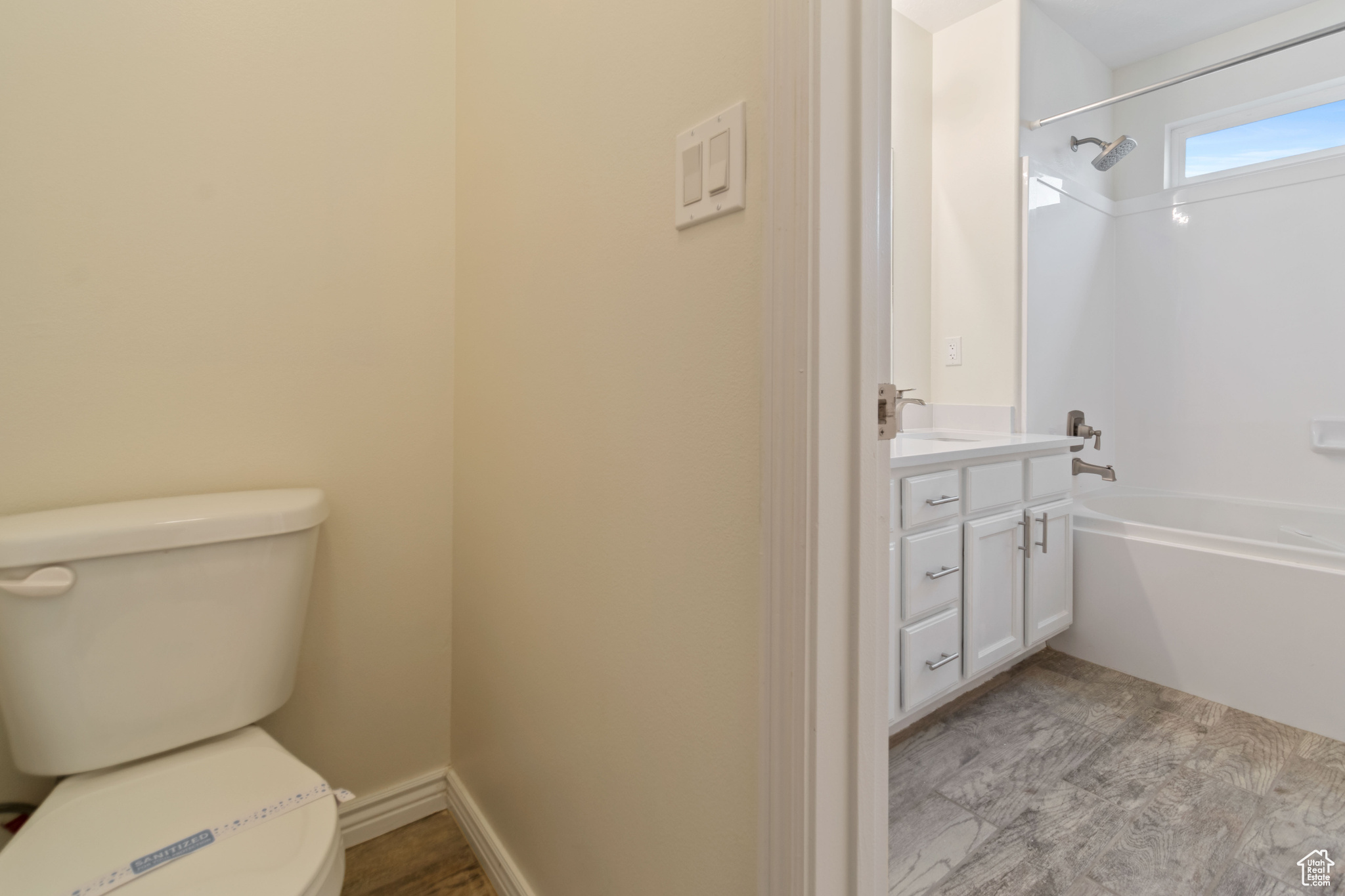 Full bathroom featuring shower / bath combination, wood-type flooring, toilet, and vanity