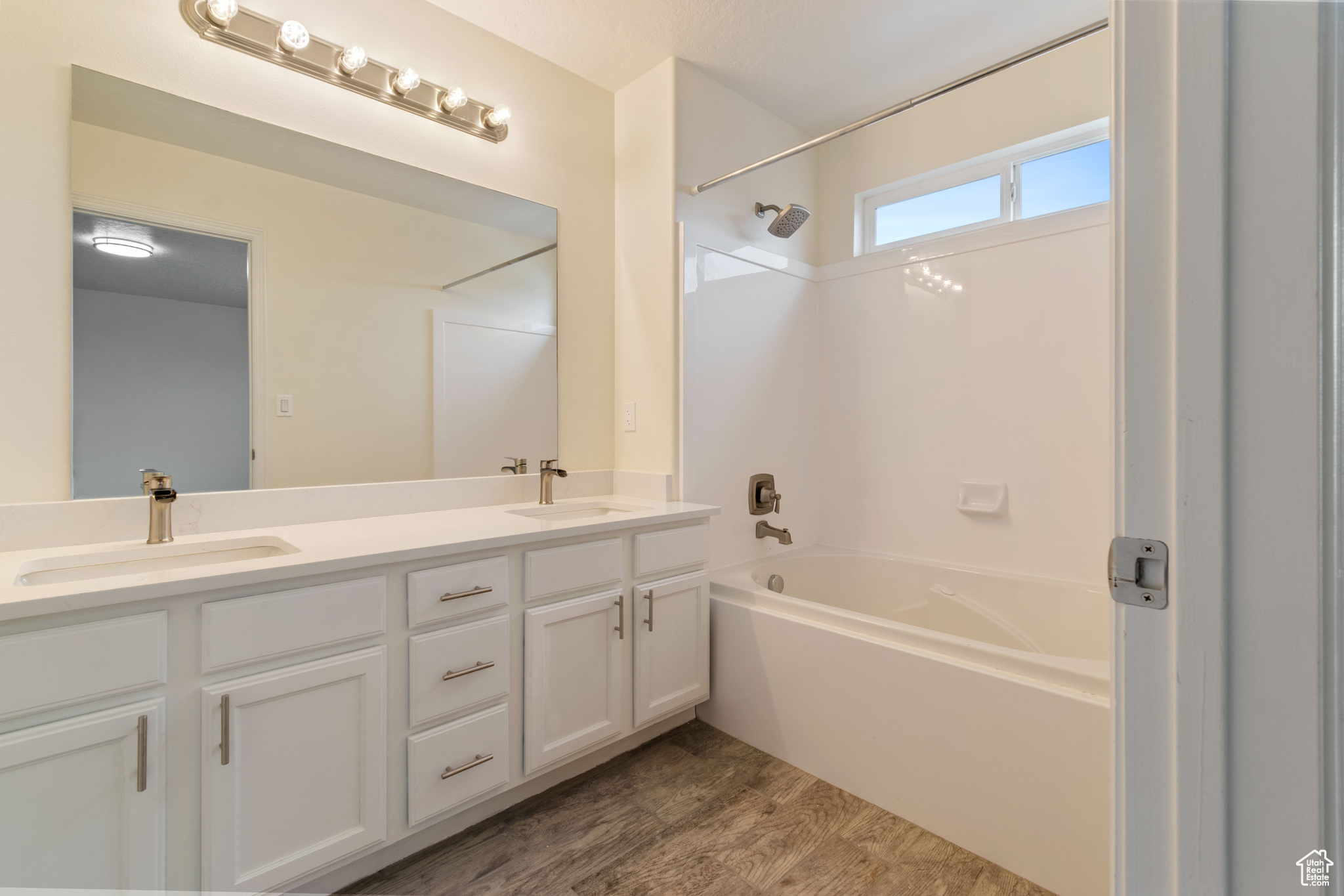 Bathroom with hardwood / wood-style flooring and dual vanity