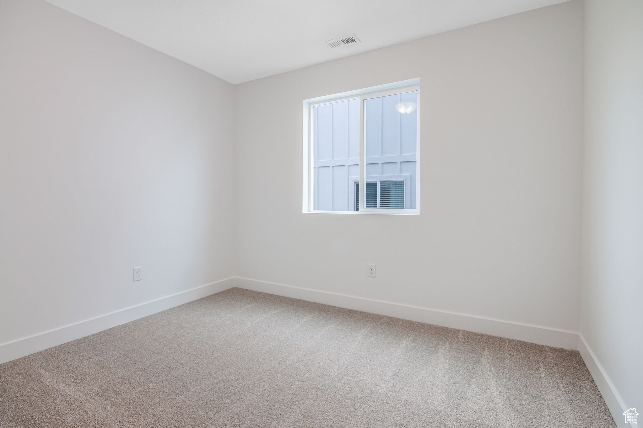 Empty room featuring carpet flooring