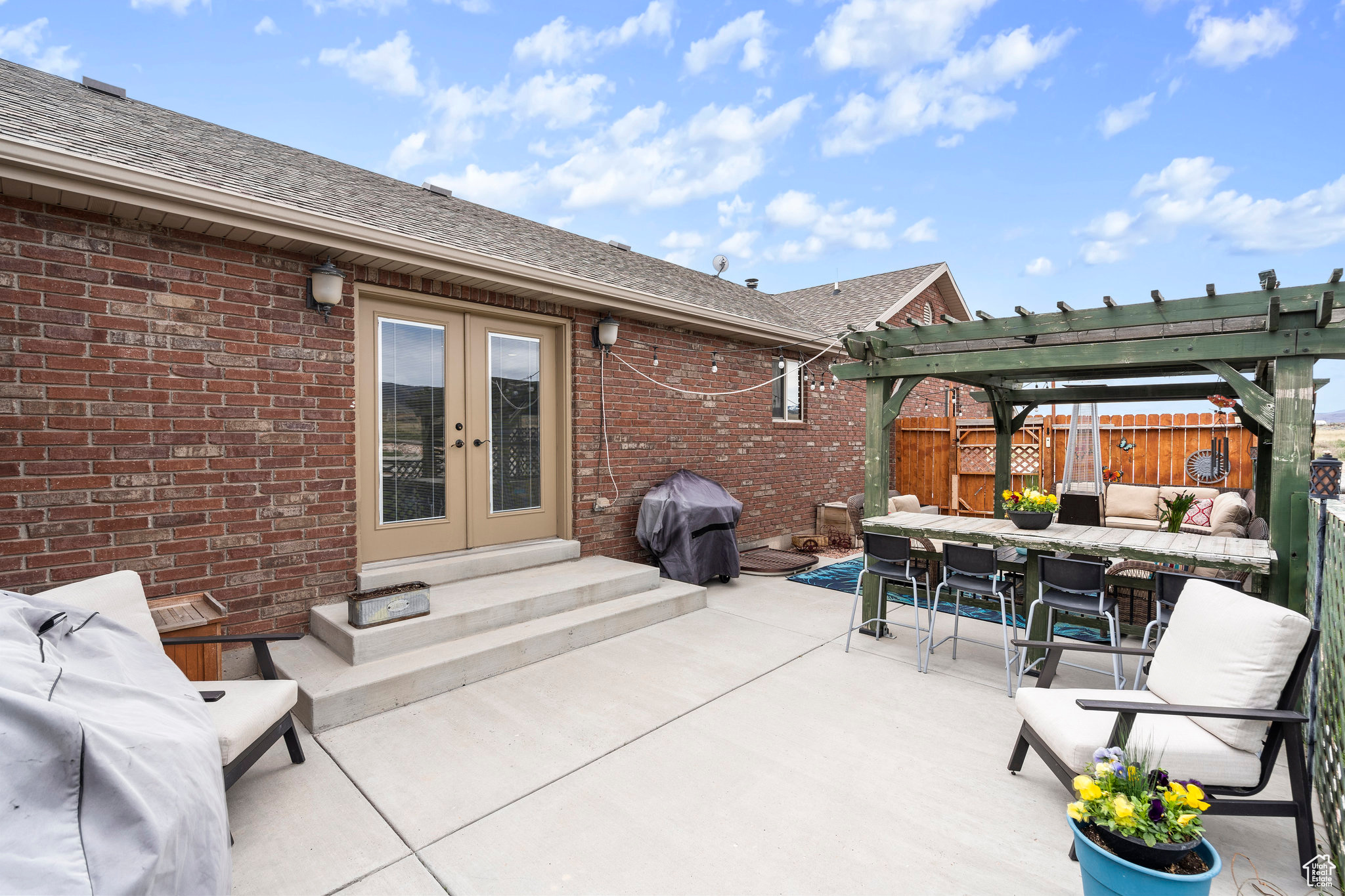 View of patio featuring area for grilling, french doors, and a pergola