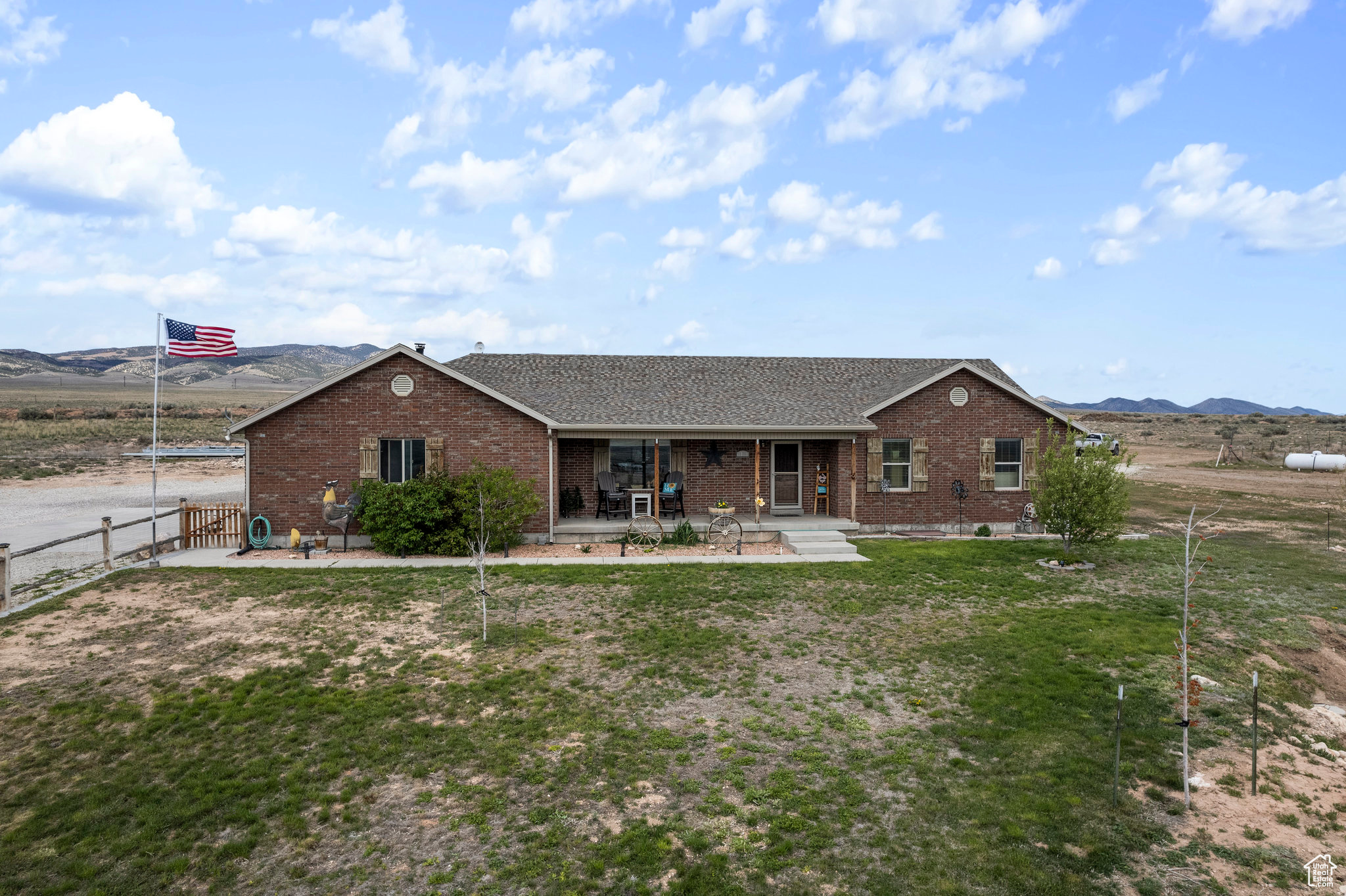 Ranch-style house with a patio and a front lawn