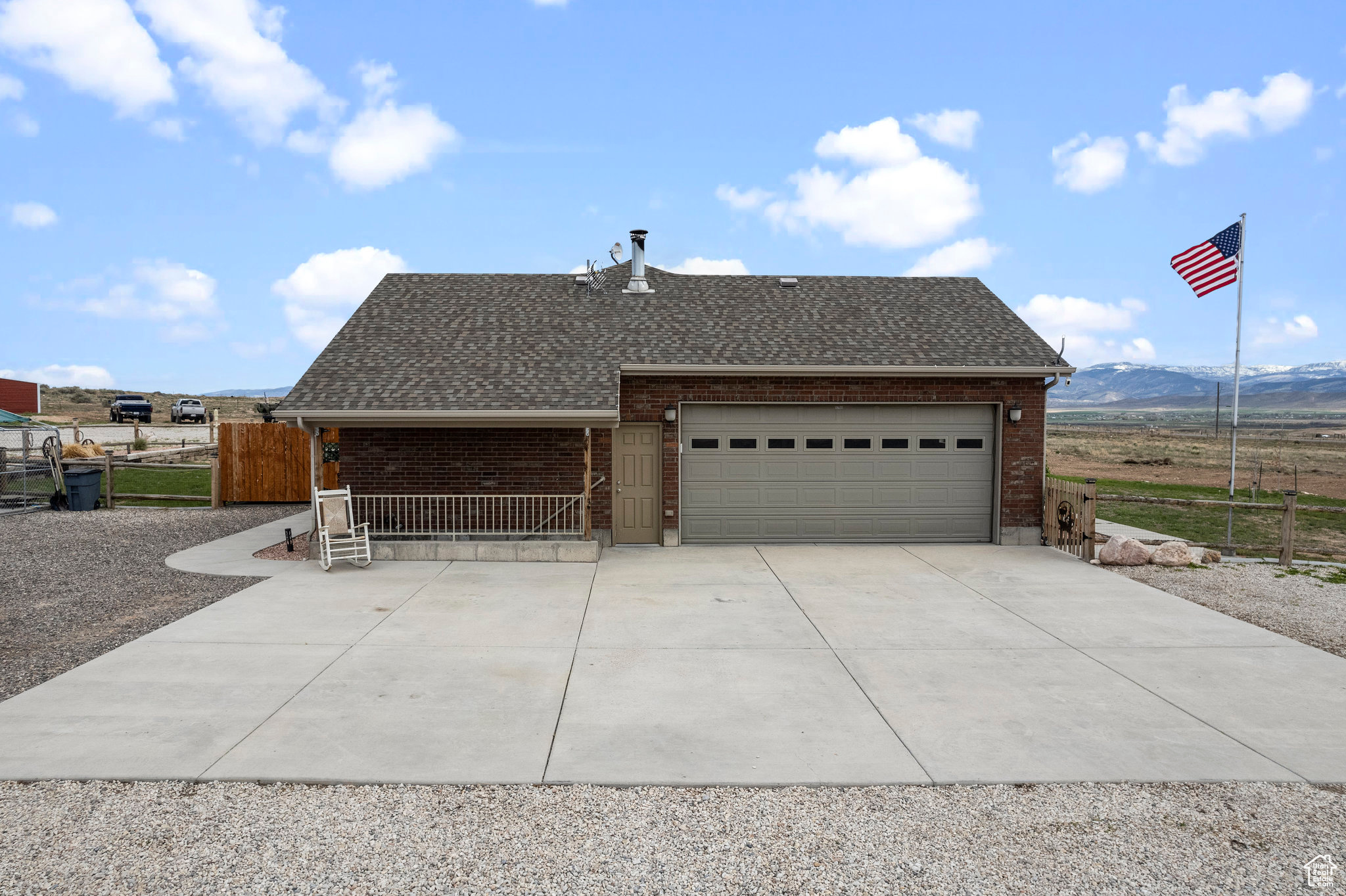 View of front facade with a mountain view and a garage