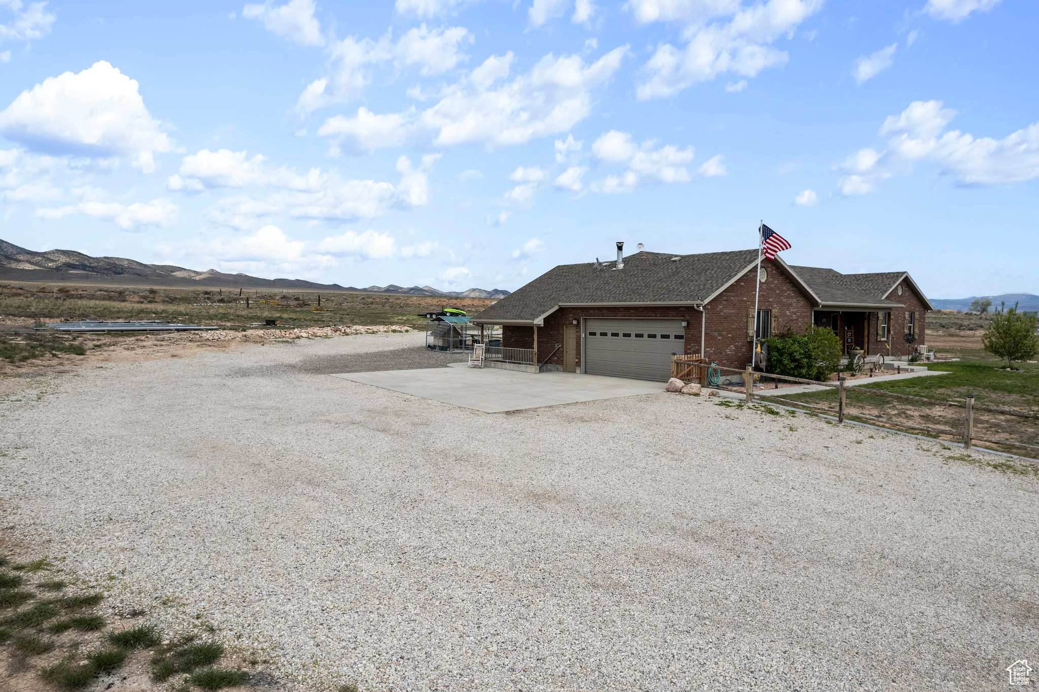 View of front of home with a mountain view and a garage