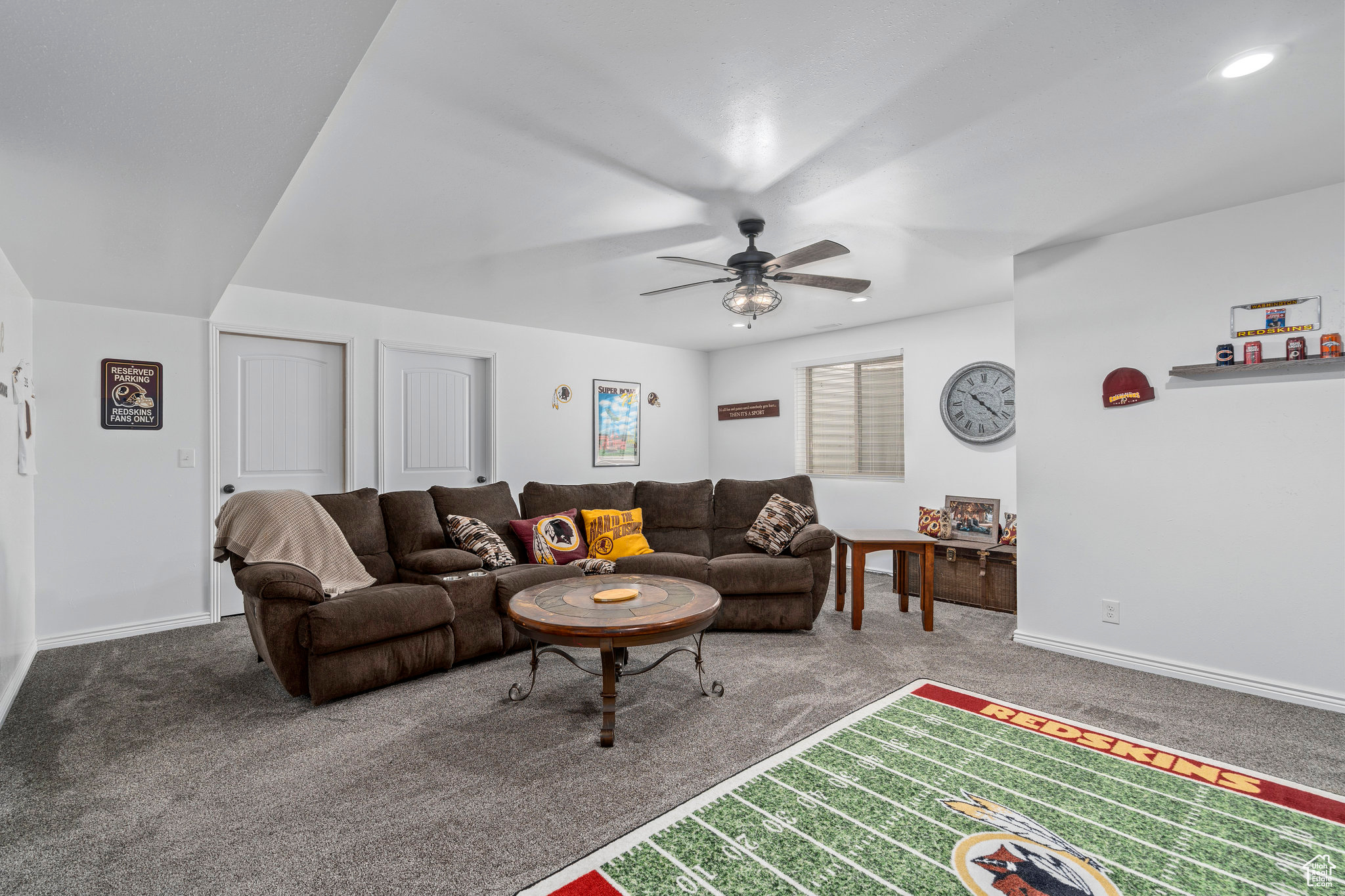 Living room featuring ceiling fan and carpet flooring