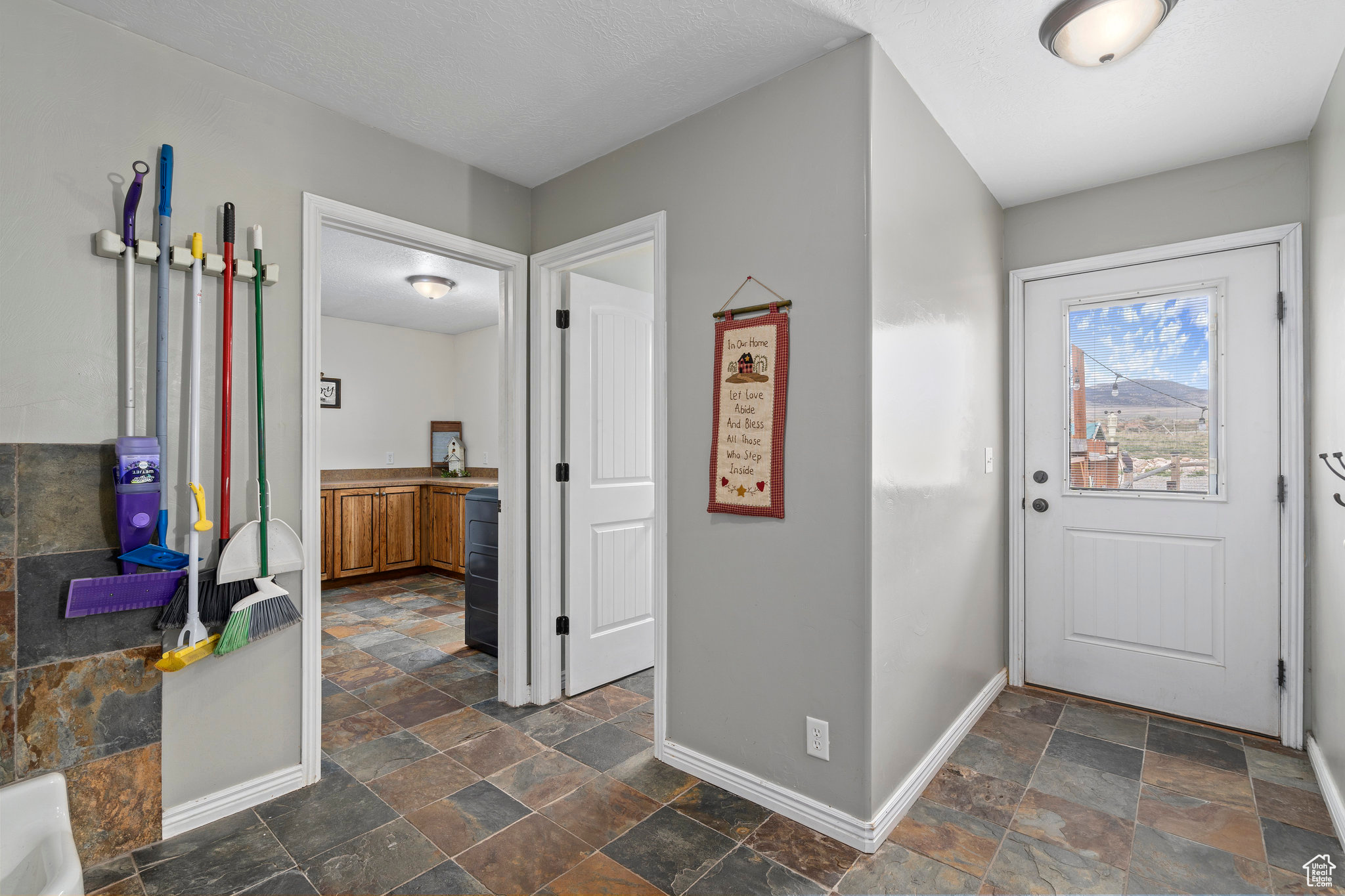 Foyer with dark tile flooring