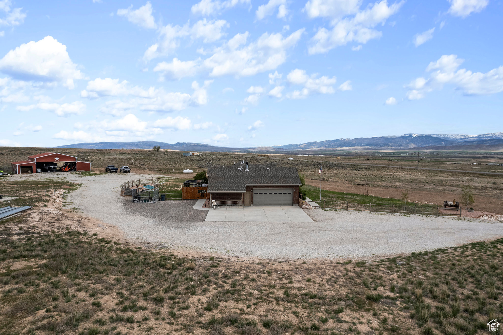 View of yard featuring a garage, a mountain view, an outdoor structure, and a rural view