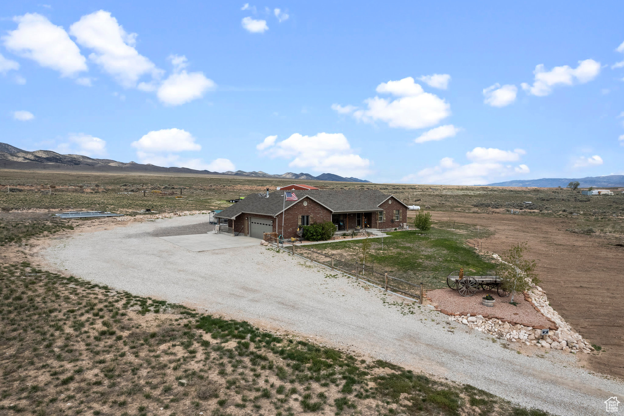 View of front of house featuring a garage, a mountain view, and a rural view