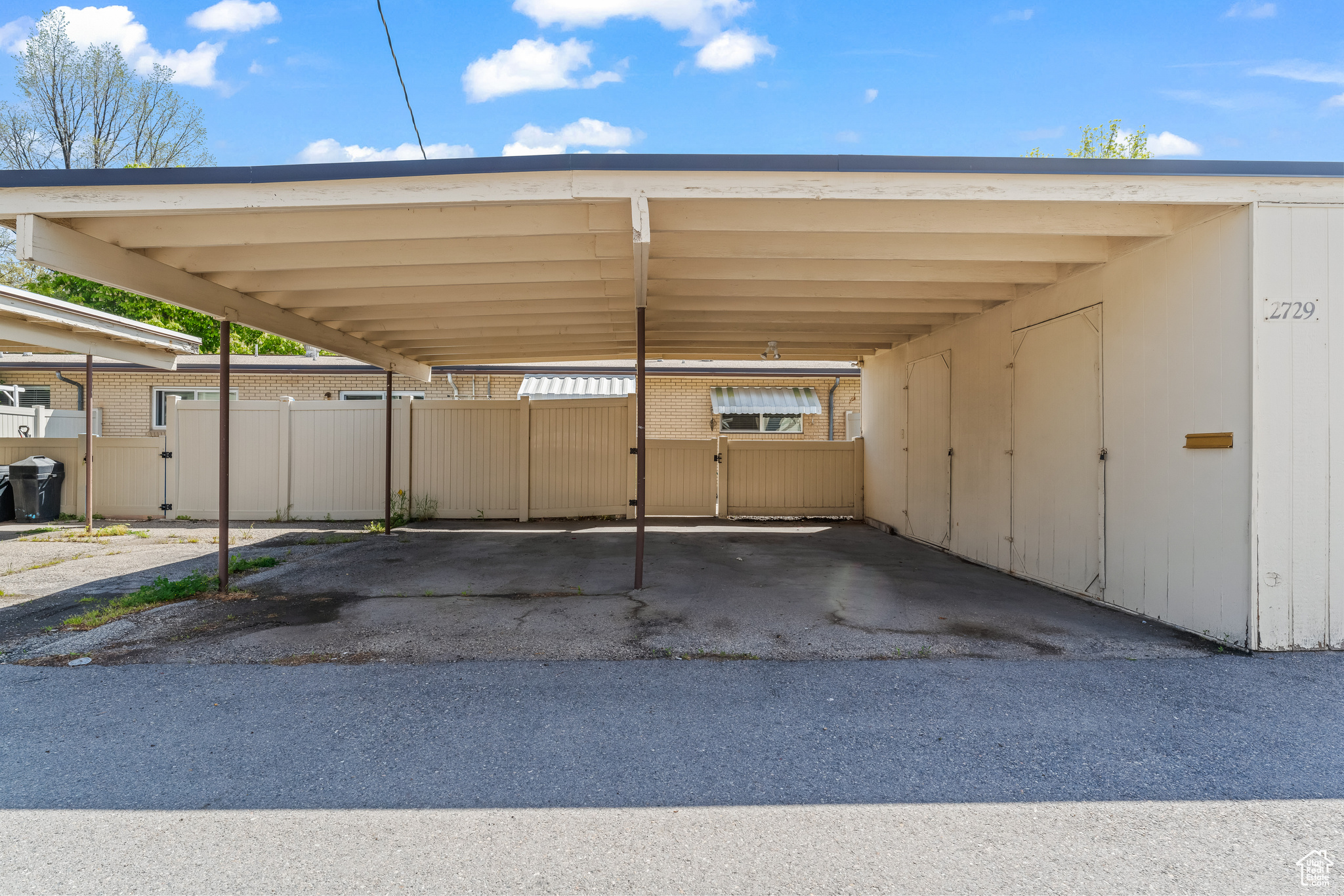 Covered double carport with large storage units