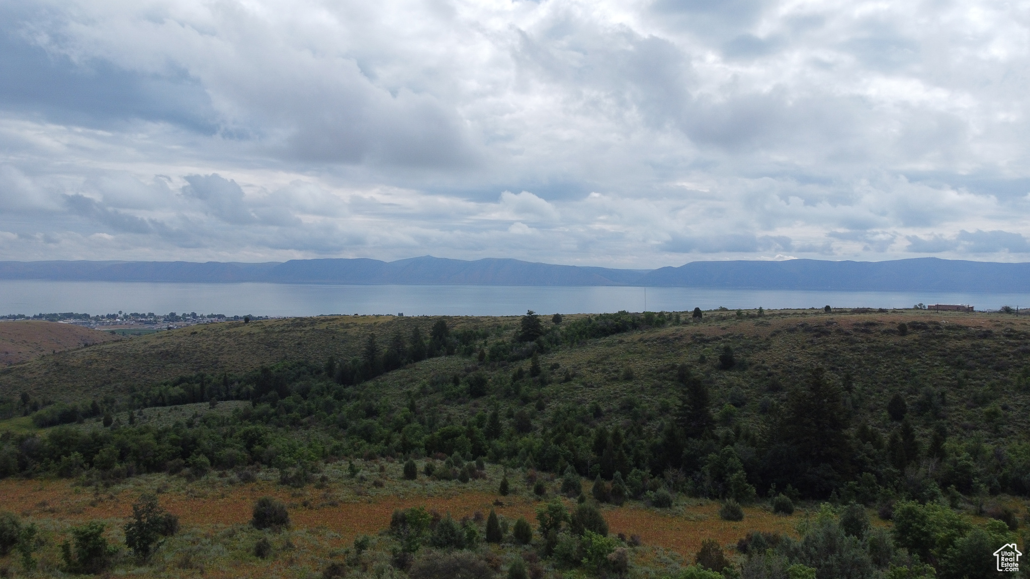 Property view of mountains with a water view