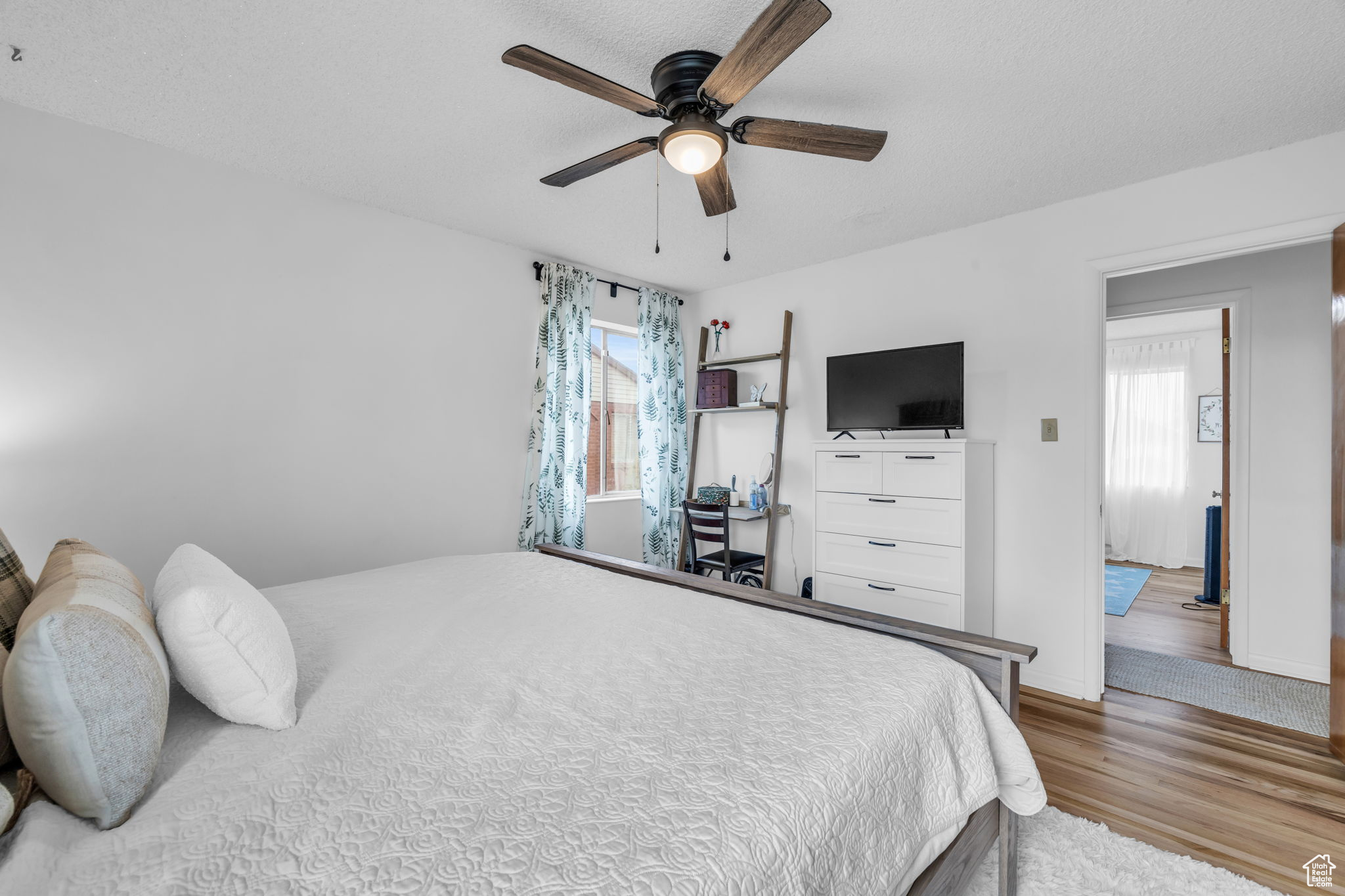 Bedroom featuring ceiling fan and light hardwood / wood-style floors