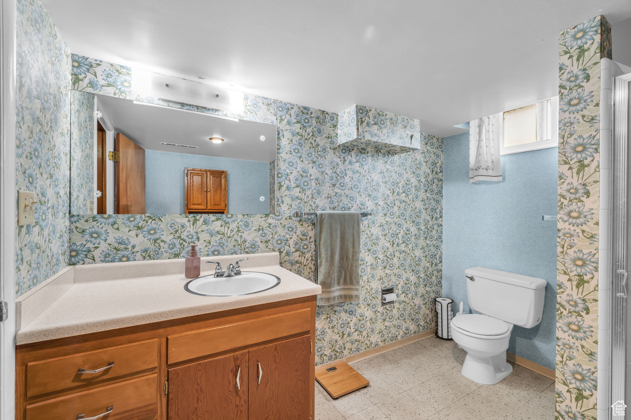 Bathroom featuring toilet, tile floors, and vanity