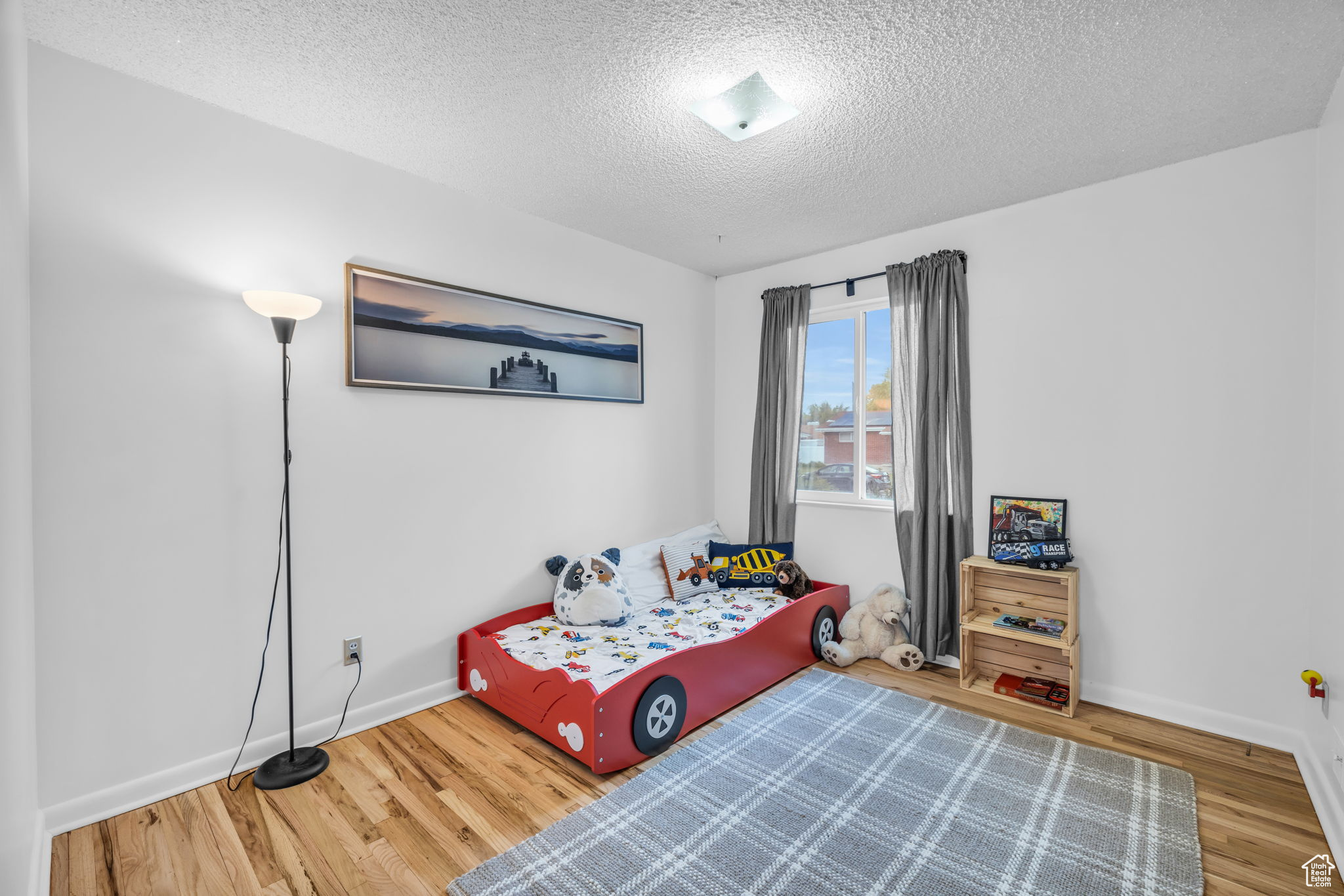 Bedroom featuring light hardwood / wood-style flooring and a textured ceiling