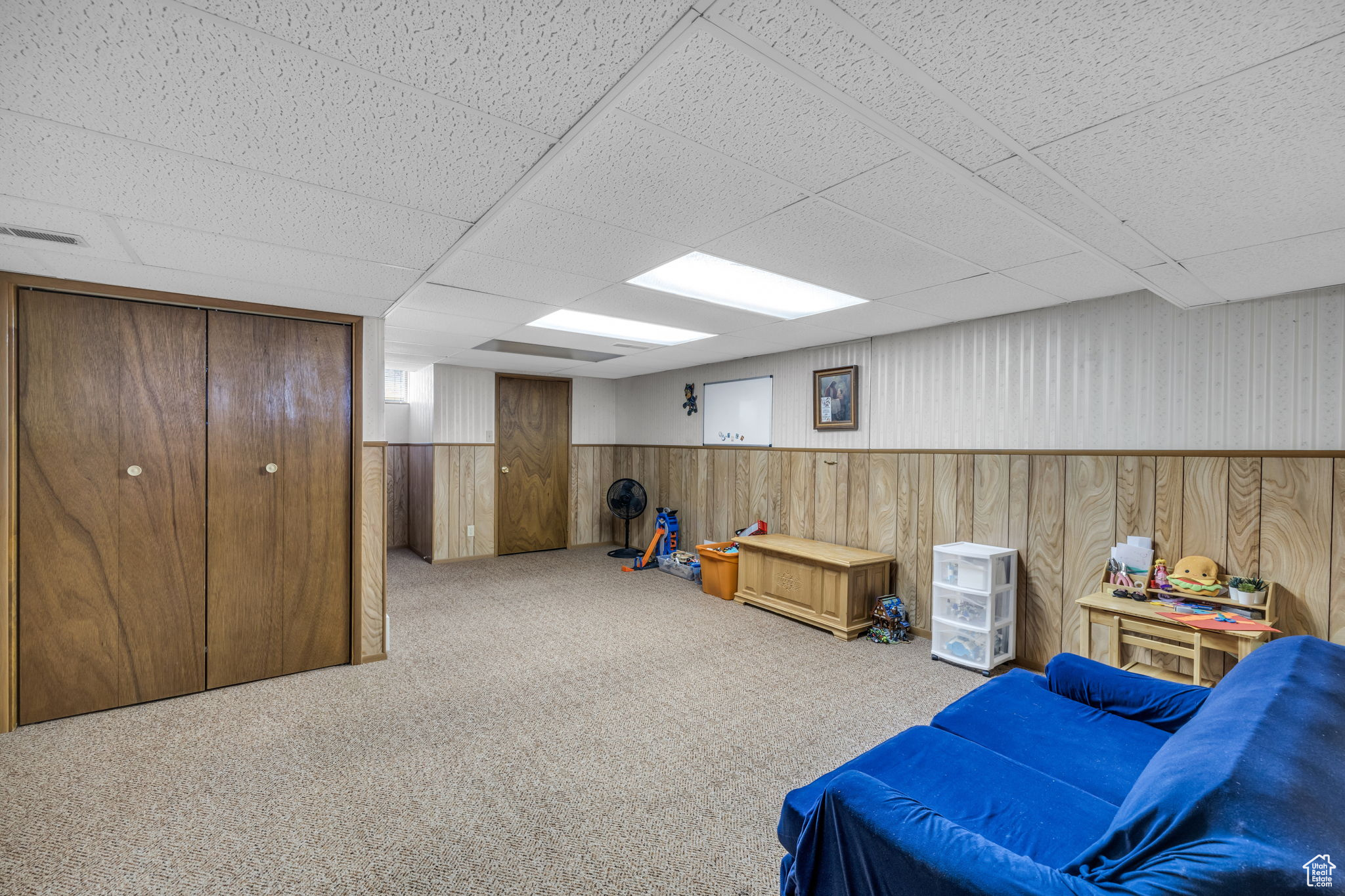 Game room featuring light colored carpet and a paneled ceiling