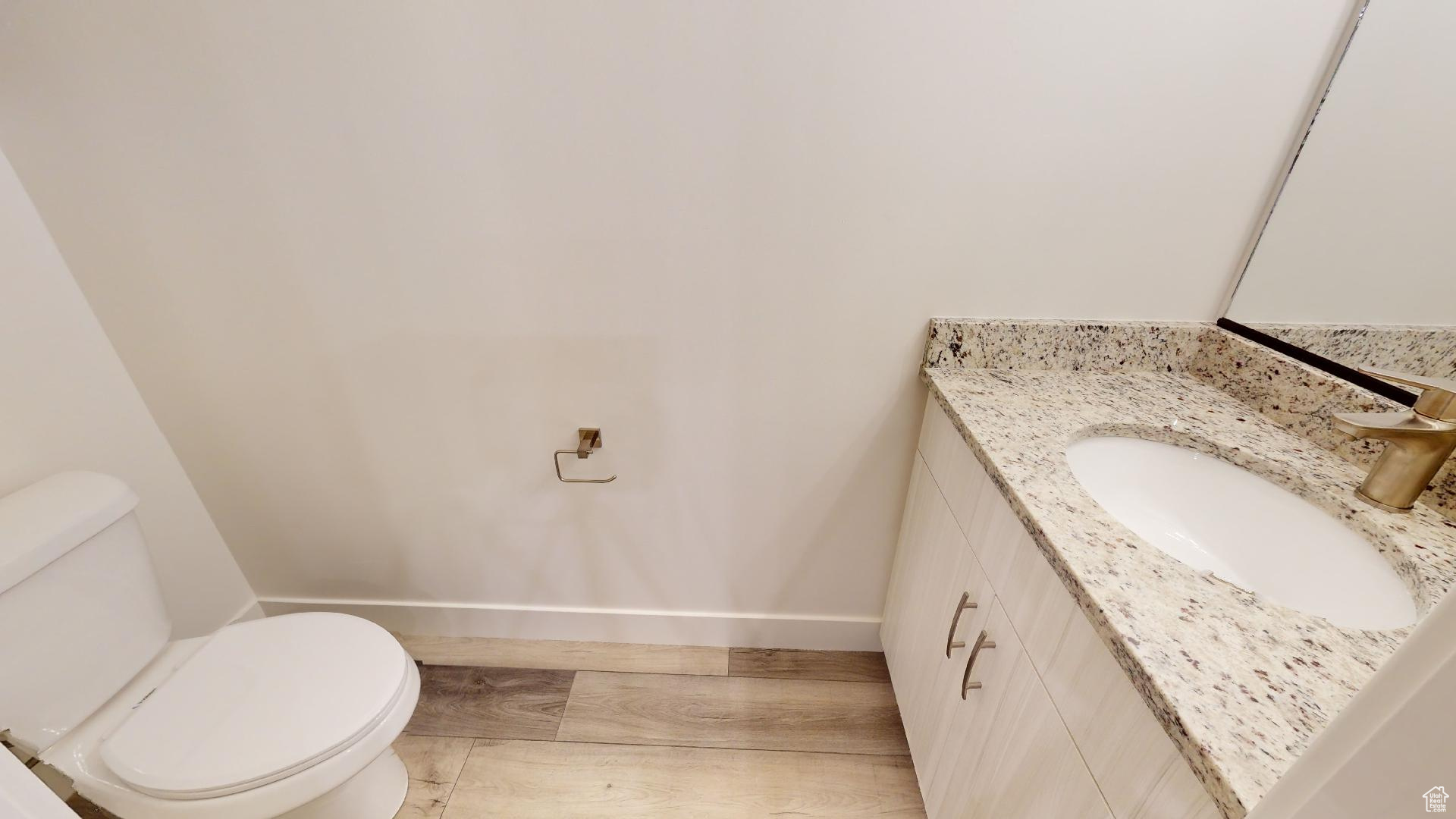 Bathroom featuring toilet, oversized vanity, and tile flooring