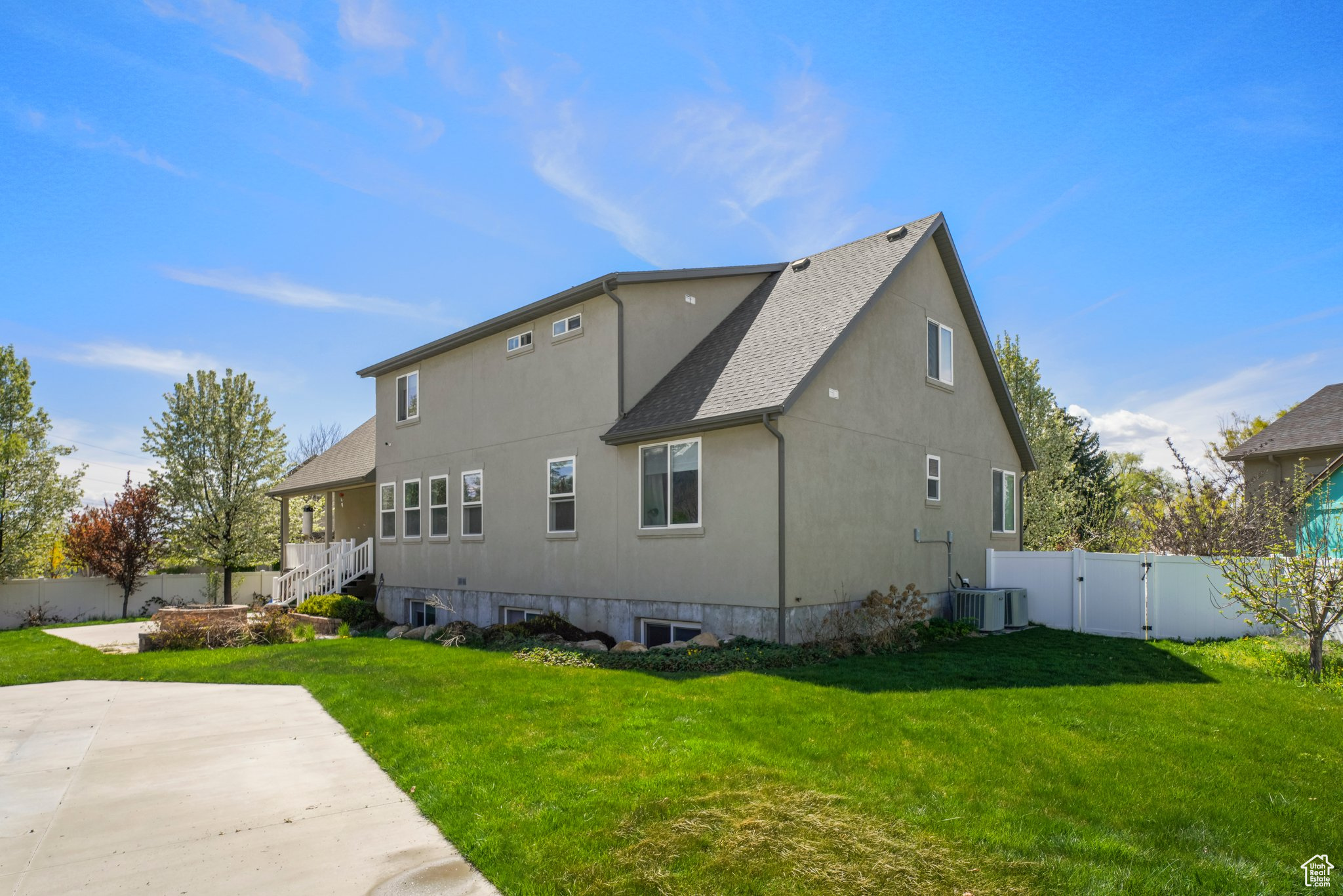 View of property exterior featuring central AC, a yard, and a patio area