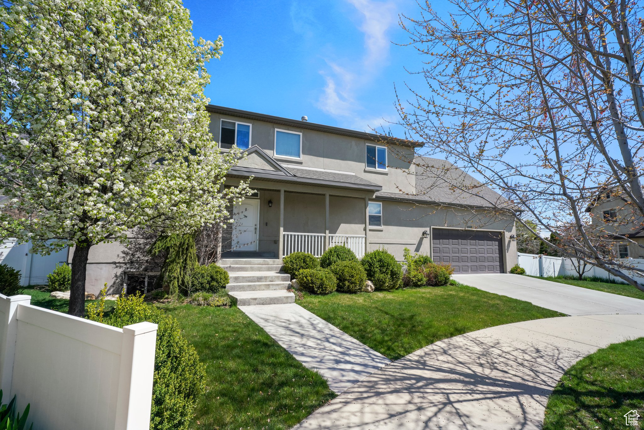 Front of property with a garage and a porch