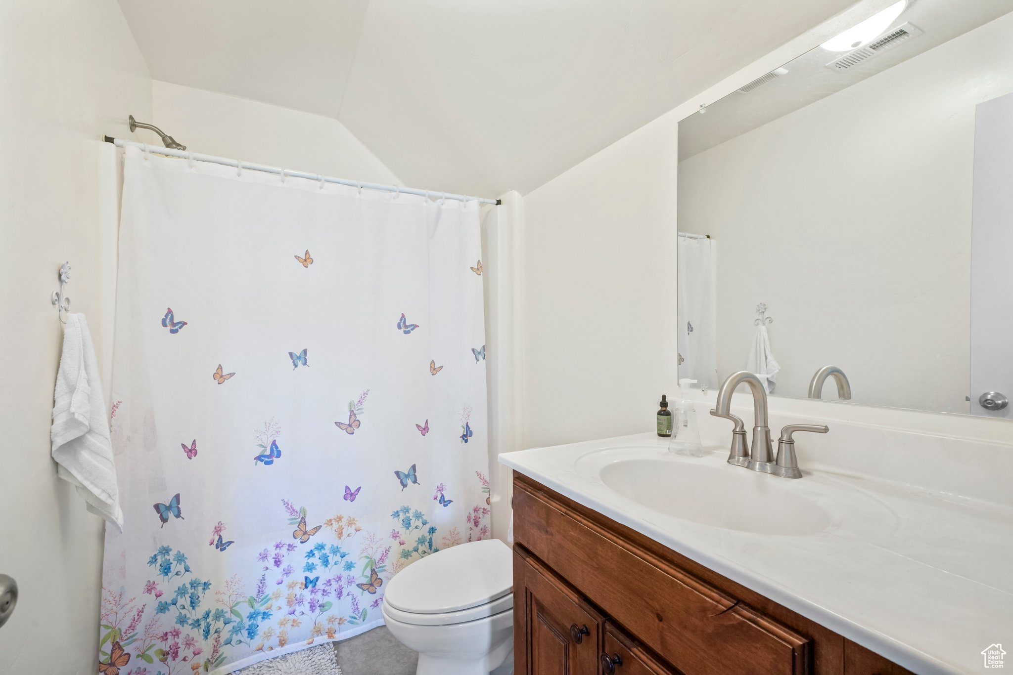 Bathroom with toilet, tile flooring, and vanity