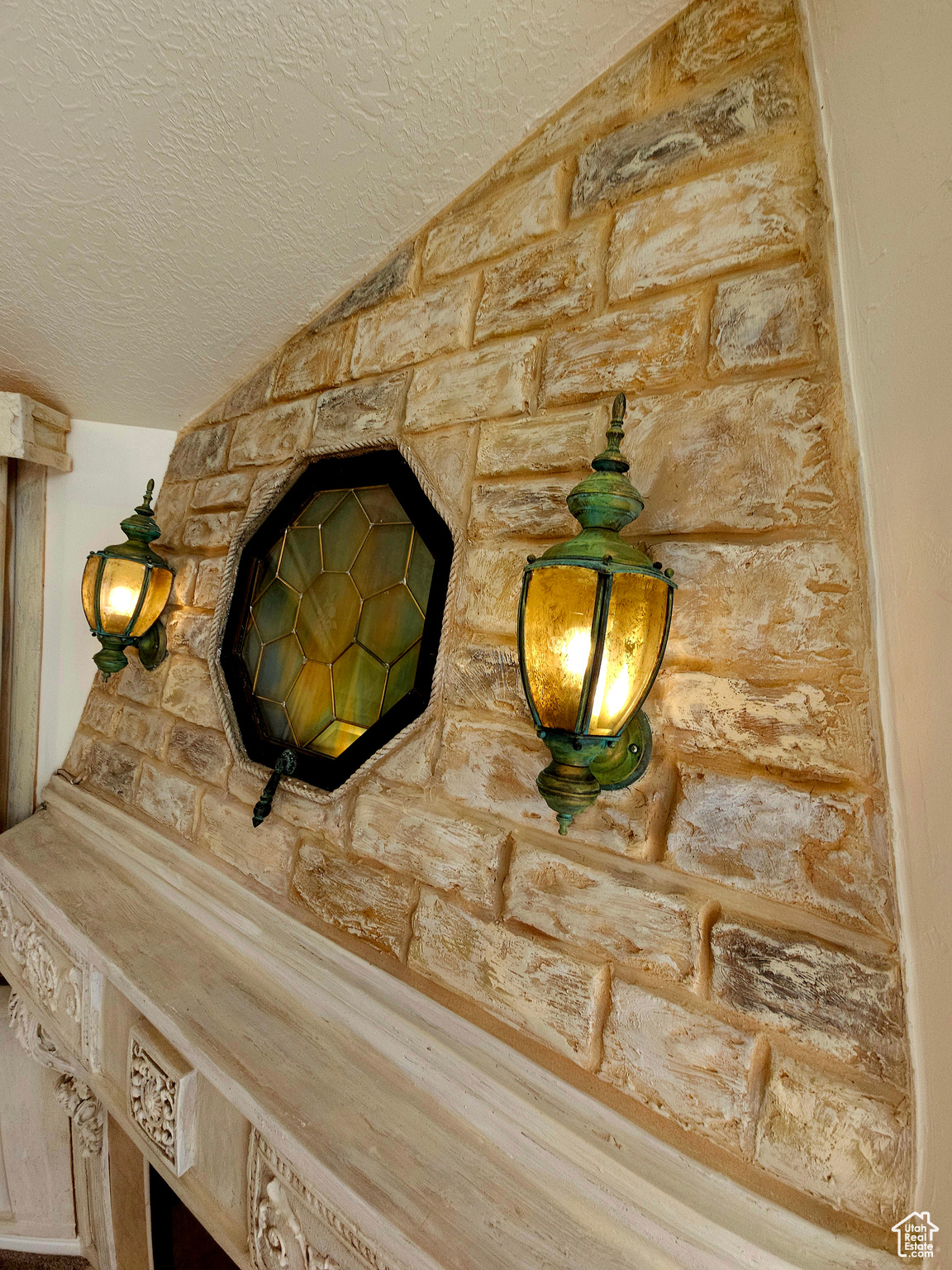 Custom hand-painted stained glass and lanterns add elegant warmth and ambiance to the great room.