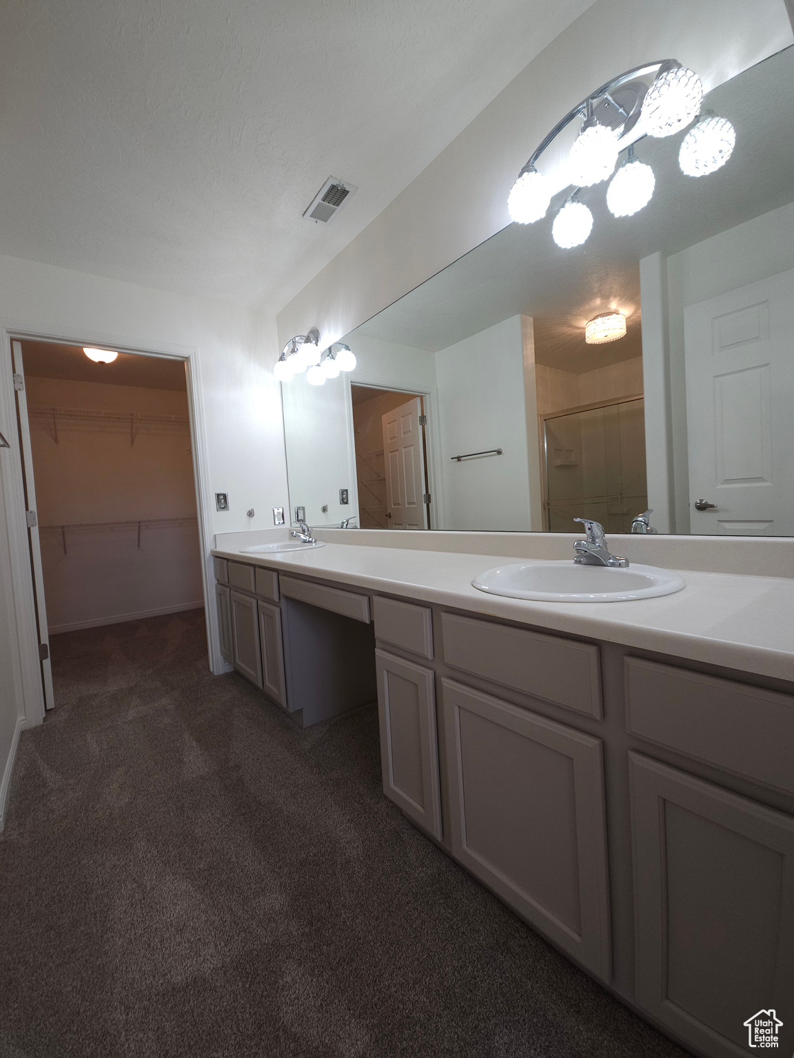Fresh paint and new carpet, compliment this double sink with makeup vanity grooming area