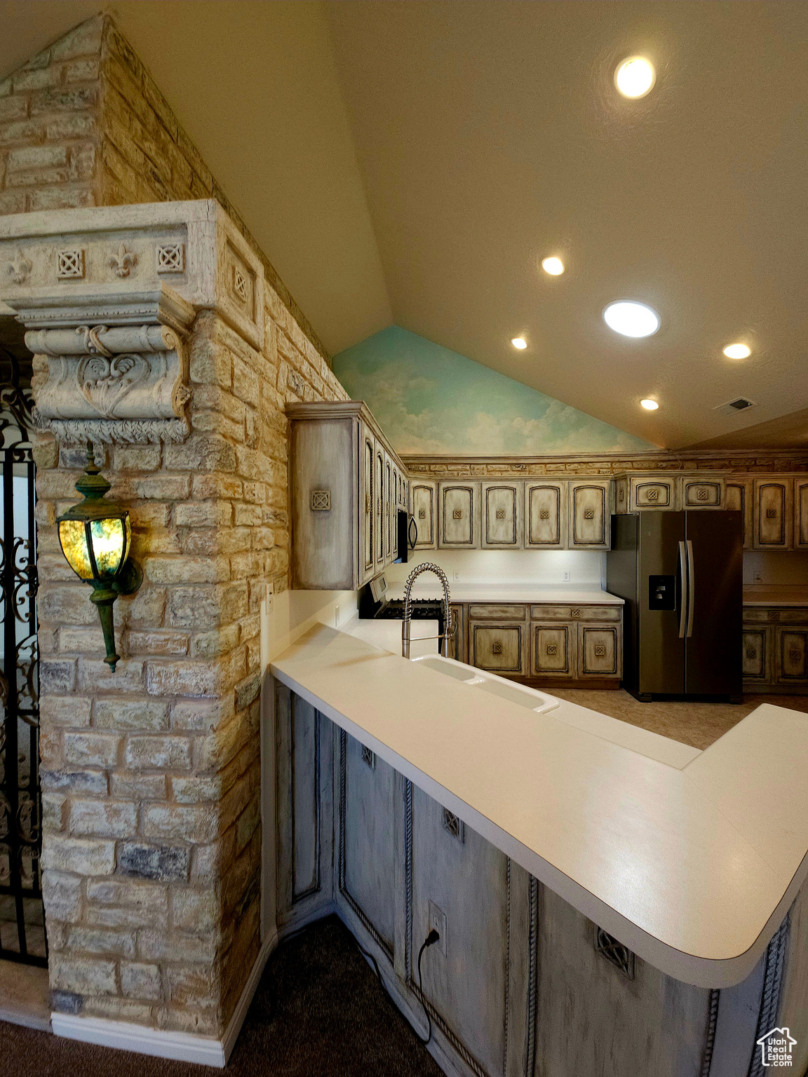 Custom stone embraces and anchors the kitchen in warmth.