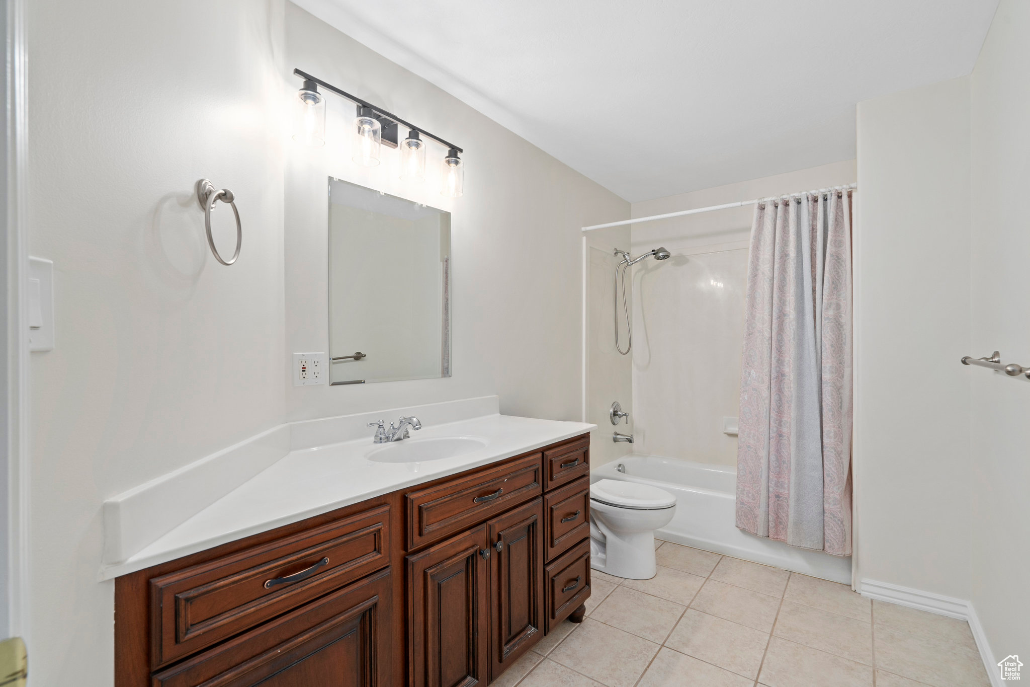 Full bathroom with toilet, shower / bath combo, tile floors, and vanity