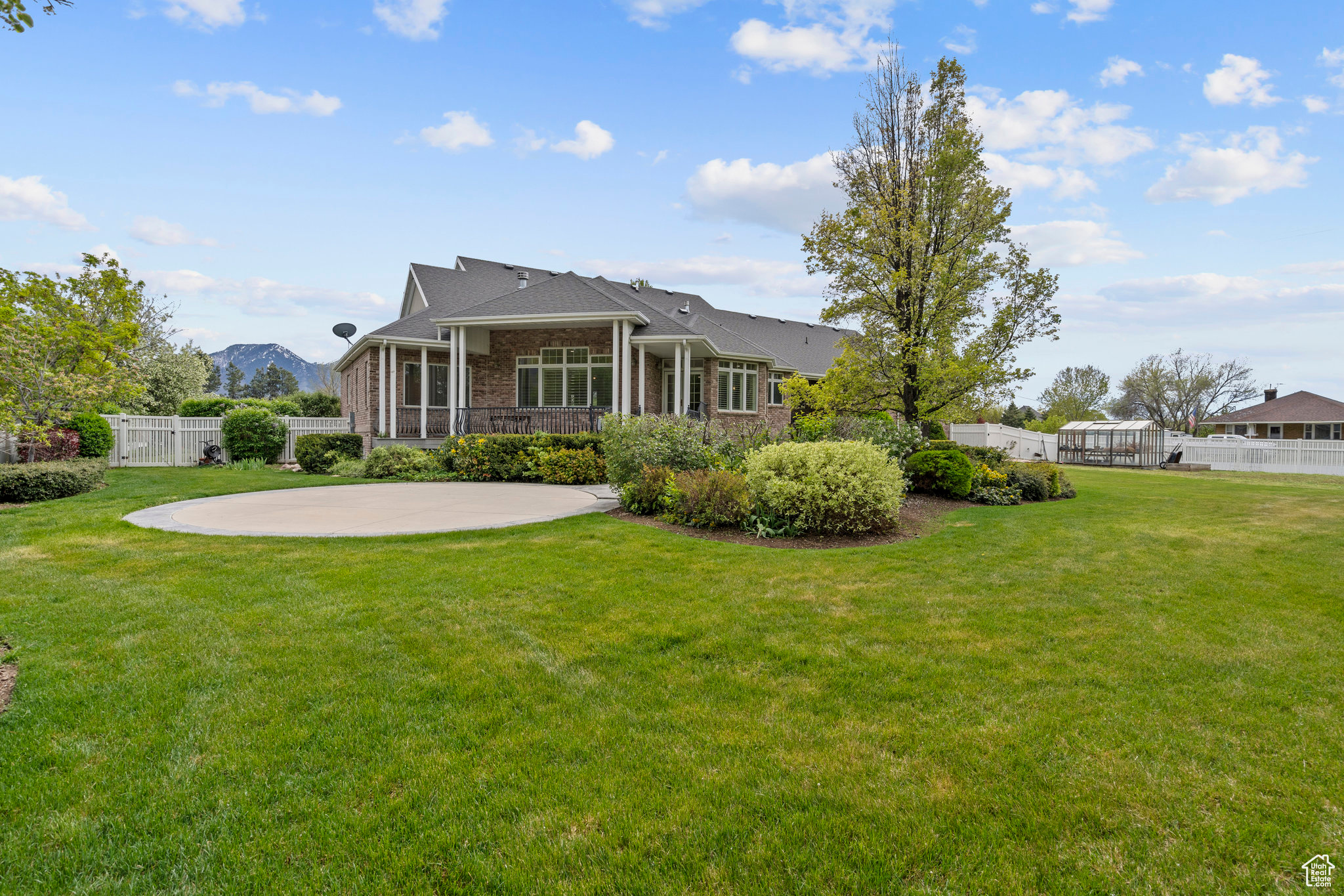 Back of property featuring a patio area and a lawn