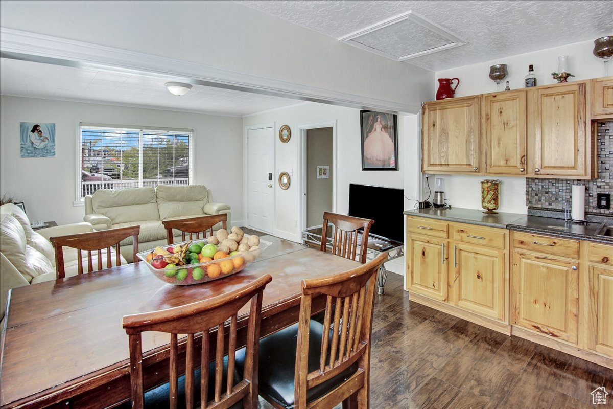 Dining area featuring a textured ceiling and dark hardwood / wood-style flooring