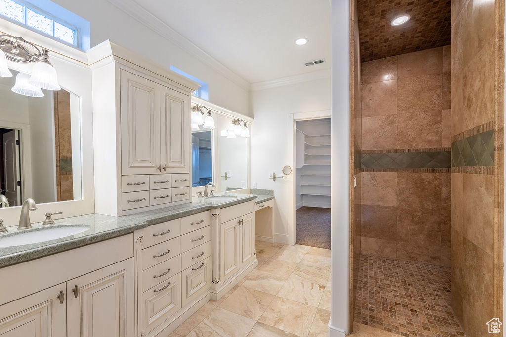 Bathroom featuring tile flooring, double vanity, and ornamental molding