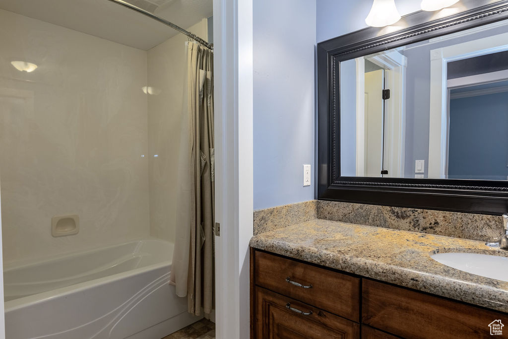 Bathroom with vanity and shower / bathtub combination with curtain