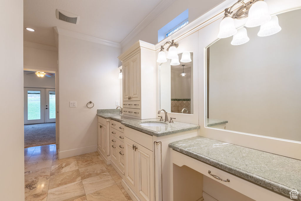 Bathroom featuring french doors, crown molding, tile floors, oversized vanity, and ceiling fan