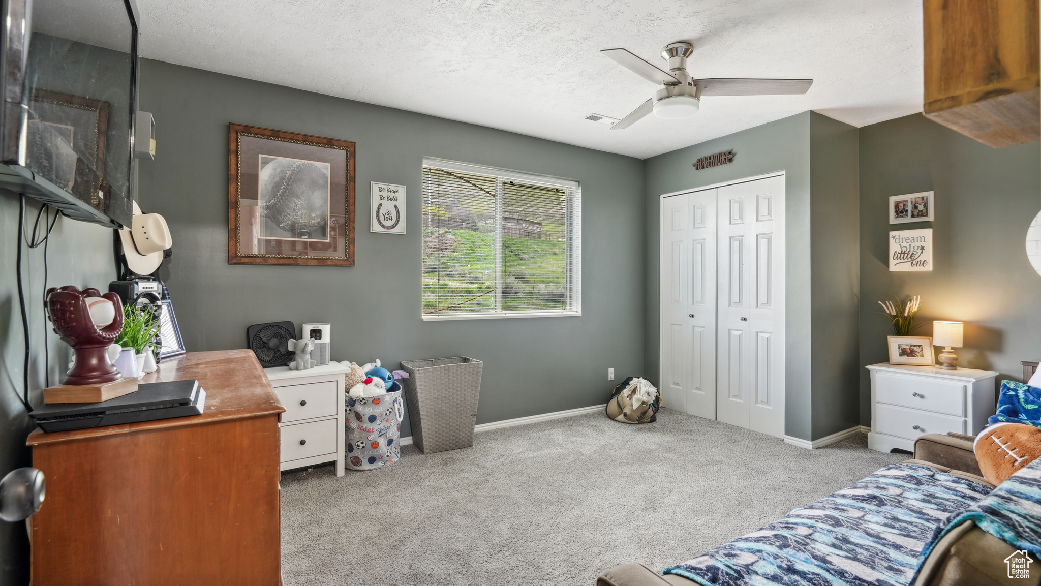 Bedroom featuring a closet, a textured ceiling, ceiling fan, and carpet floors