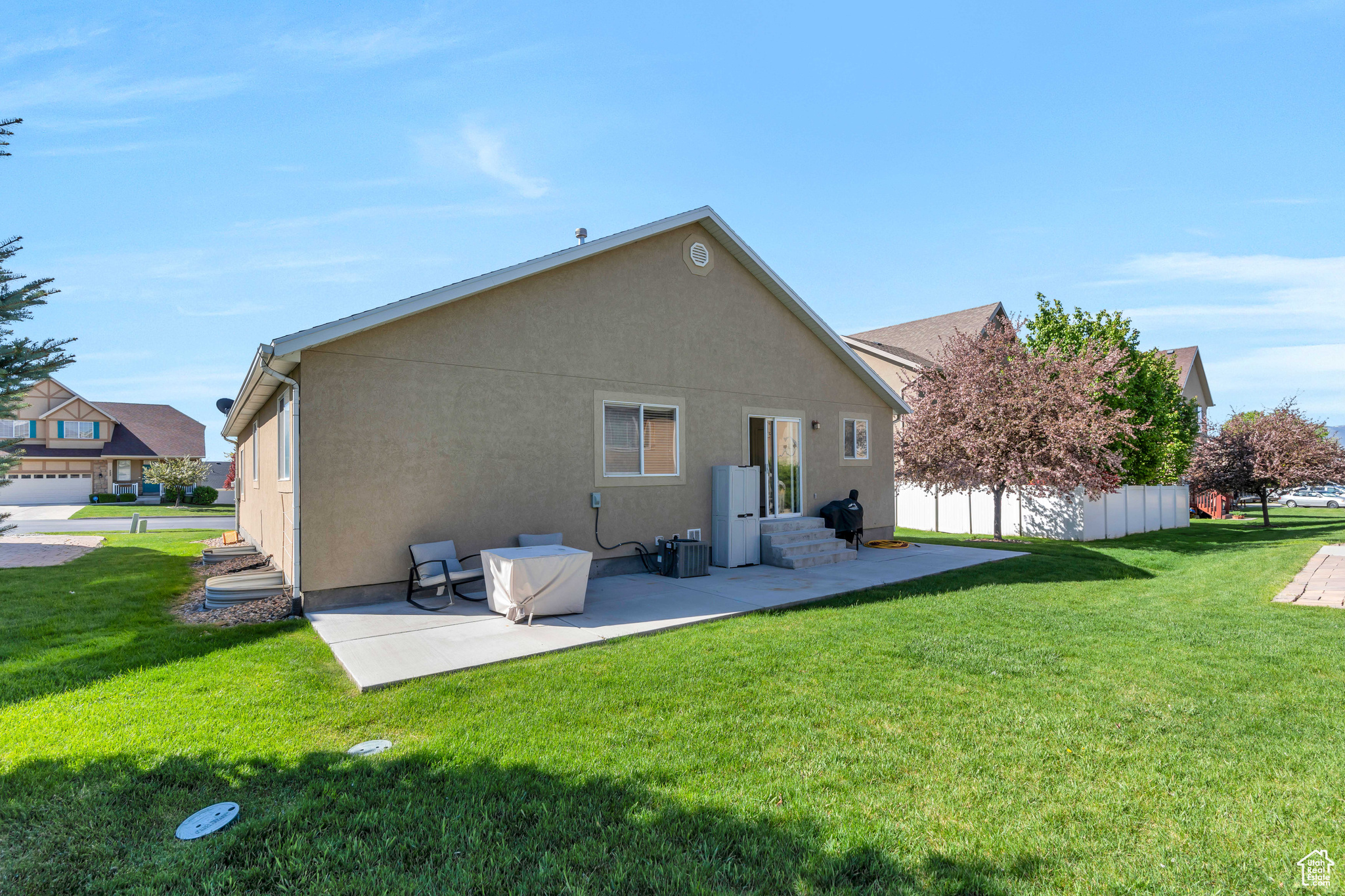 Back of property with a patio and a yard